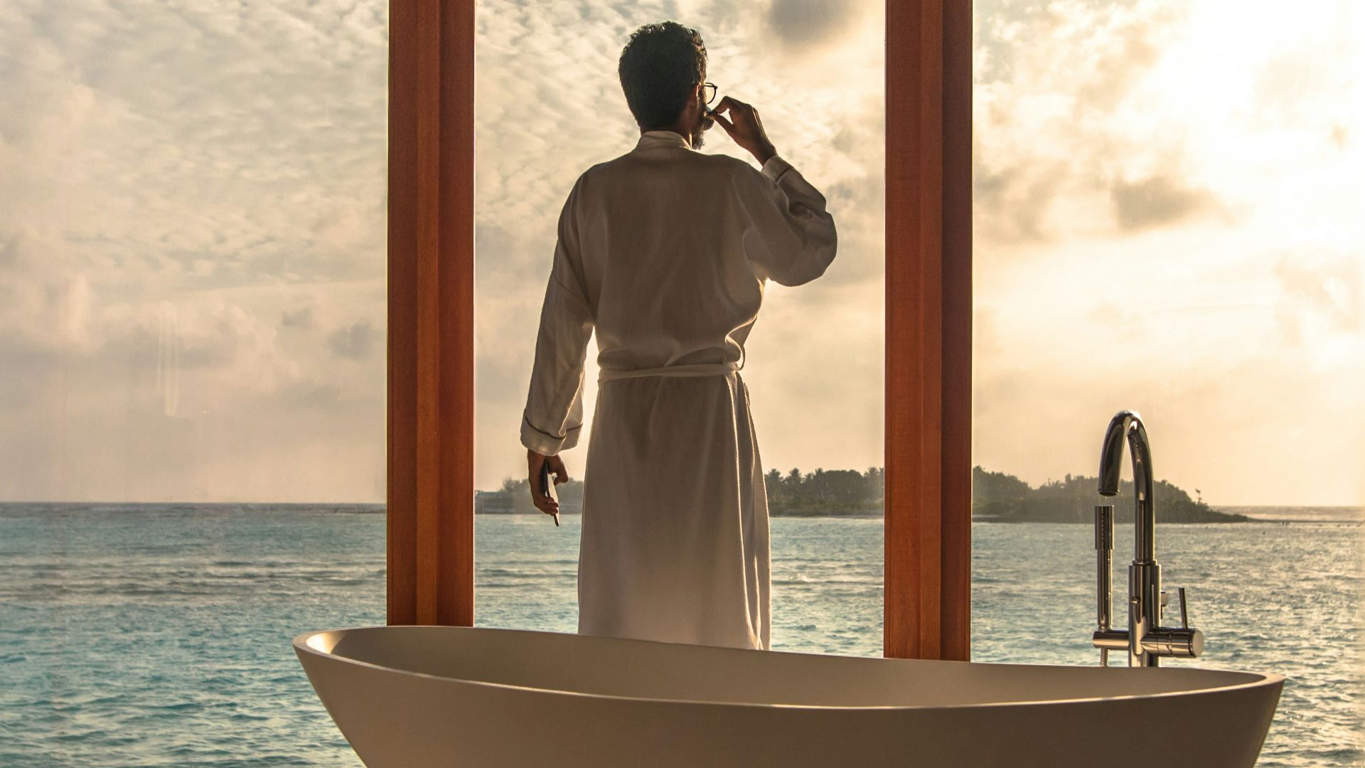 man standing beside bathtub