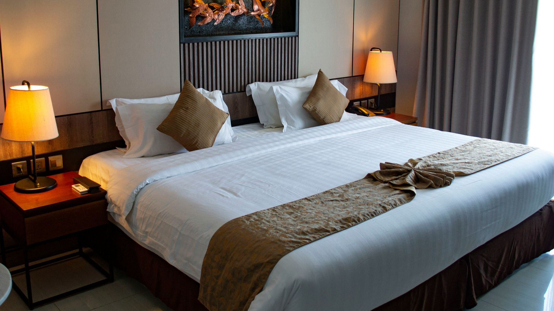 white bed linen with throw pillows