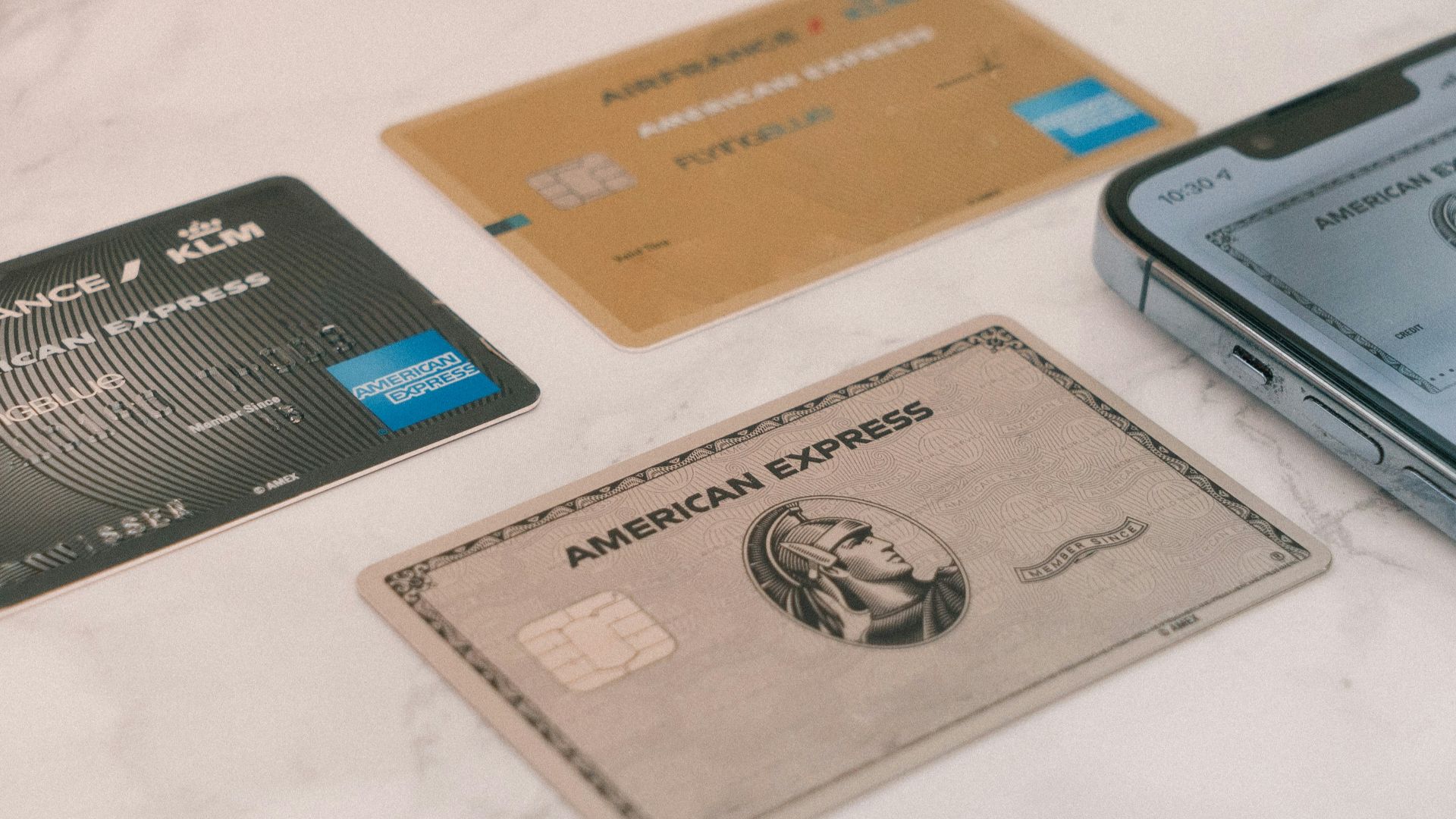 a group of credit cards sitting next to a cell phone