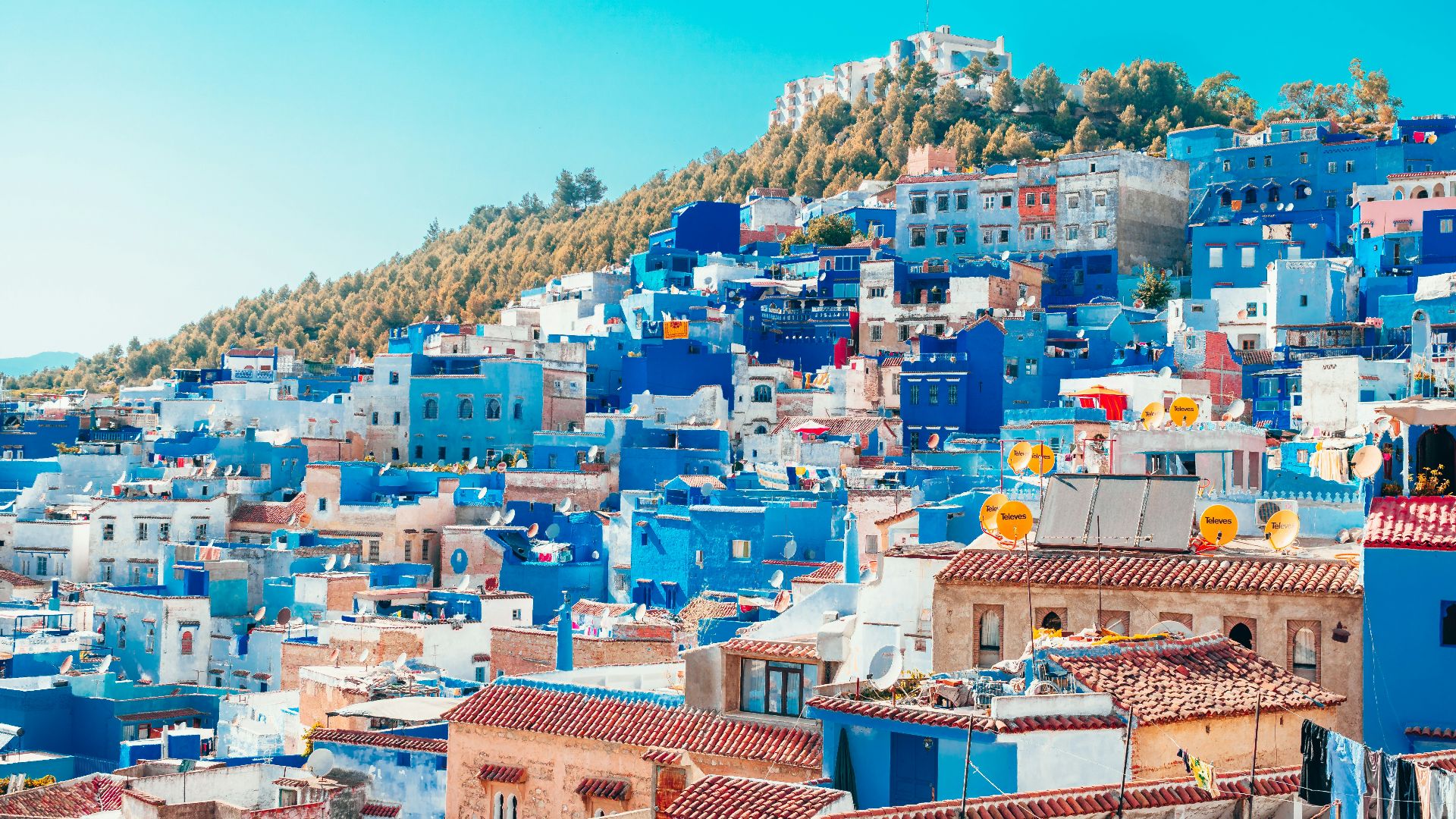 blue and white painted houses on the cliff
