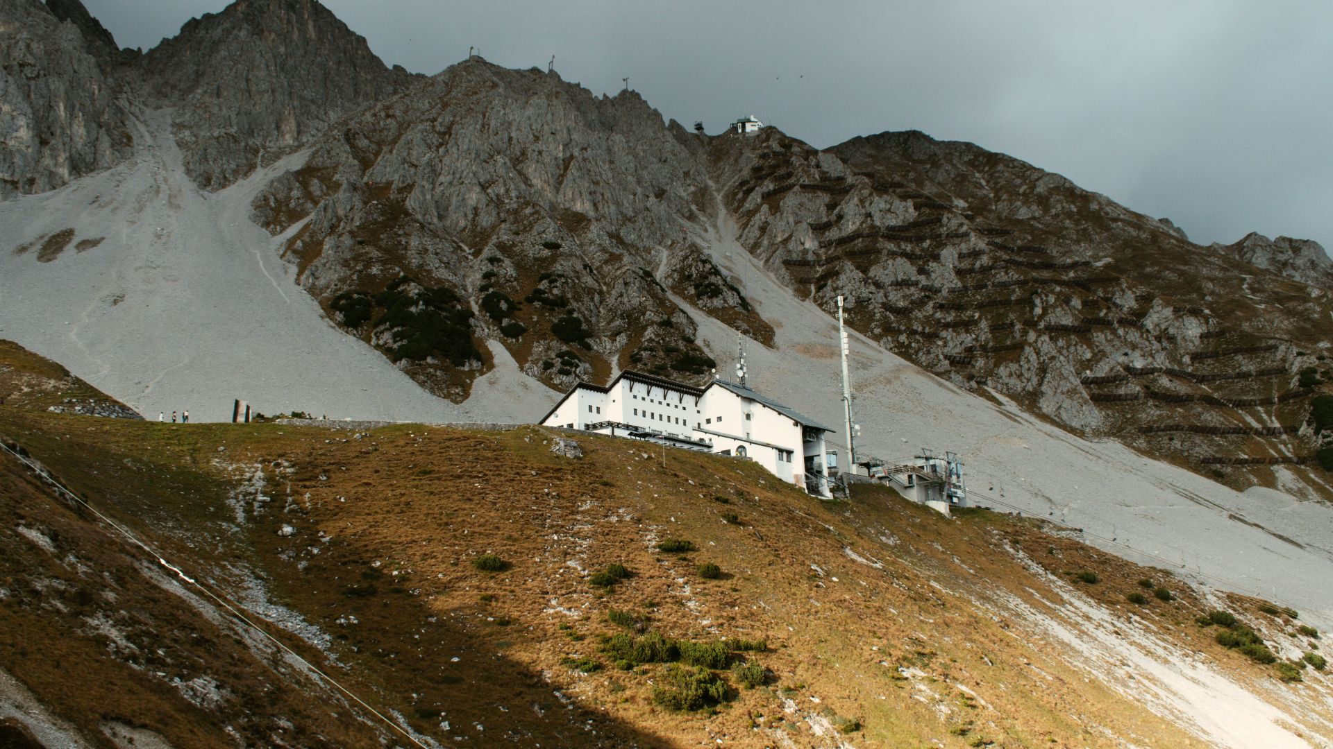 white concrete house beside mountain