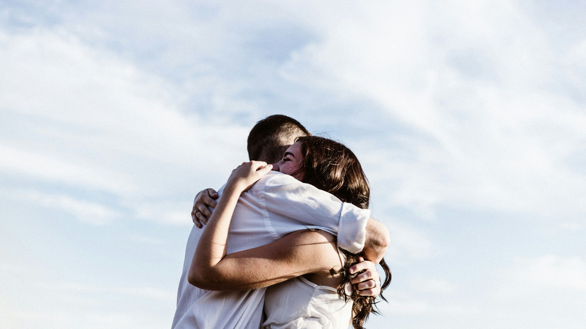 man and woman hugging each other photography
