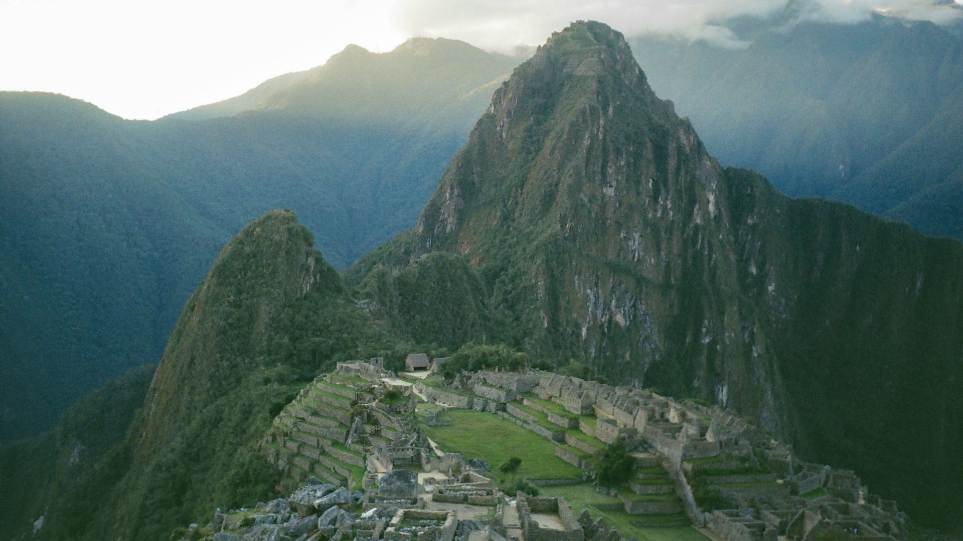 An aerial view of a mountain with a village in the foreground