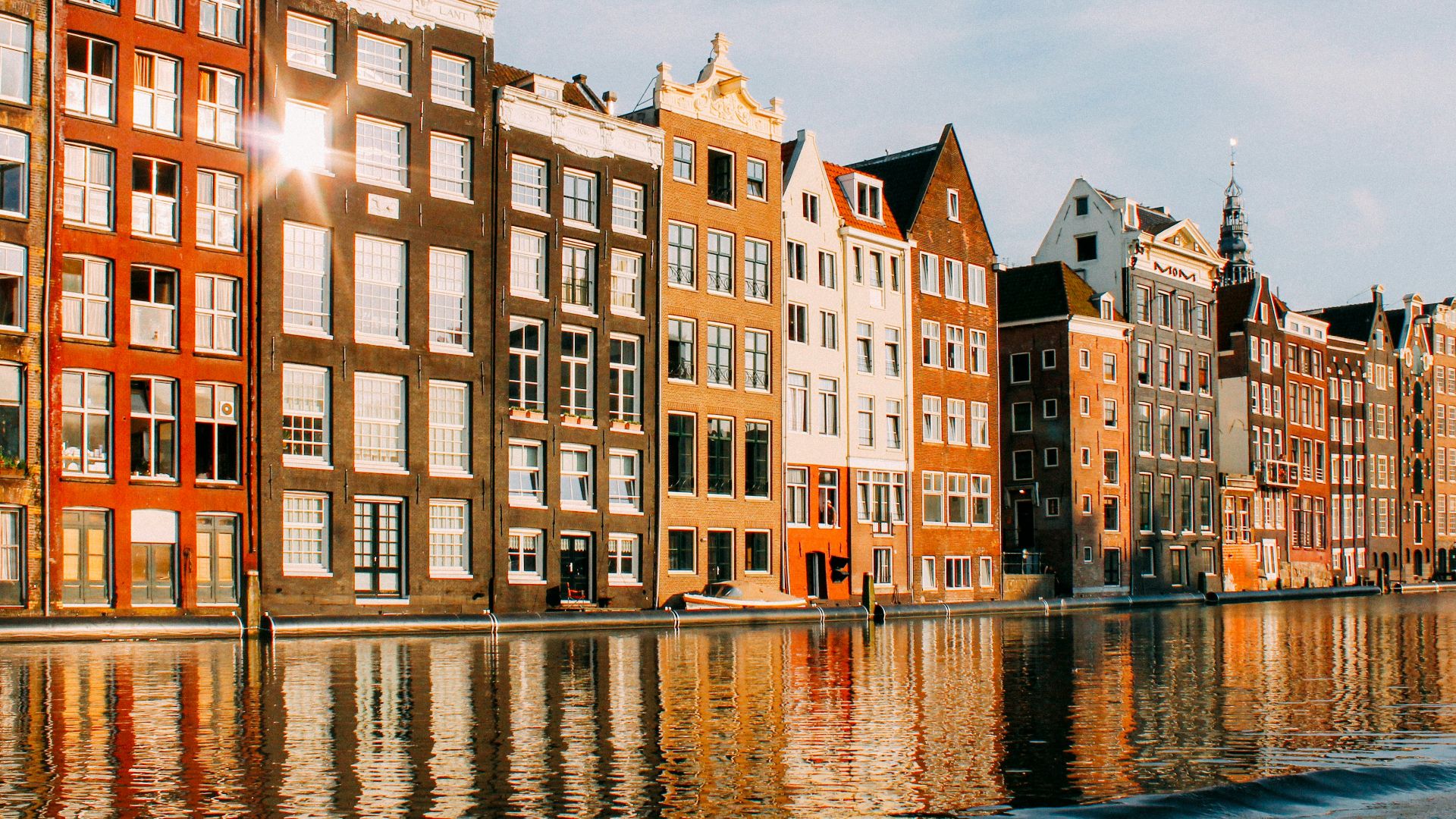 assorted-color buildings beside body of water
