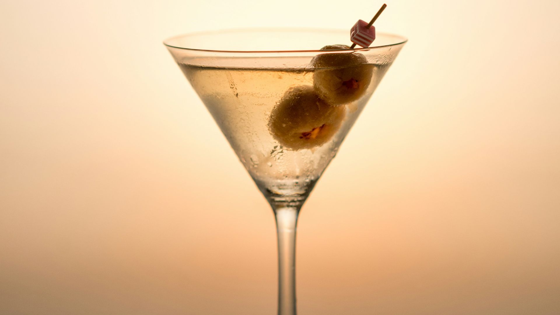 clear cocktail glass with yellow liquid