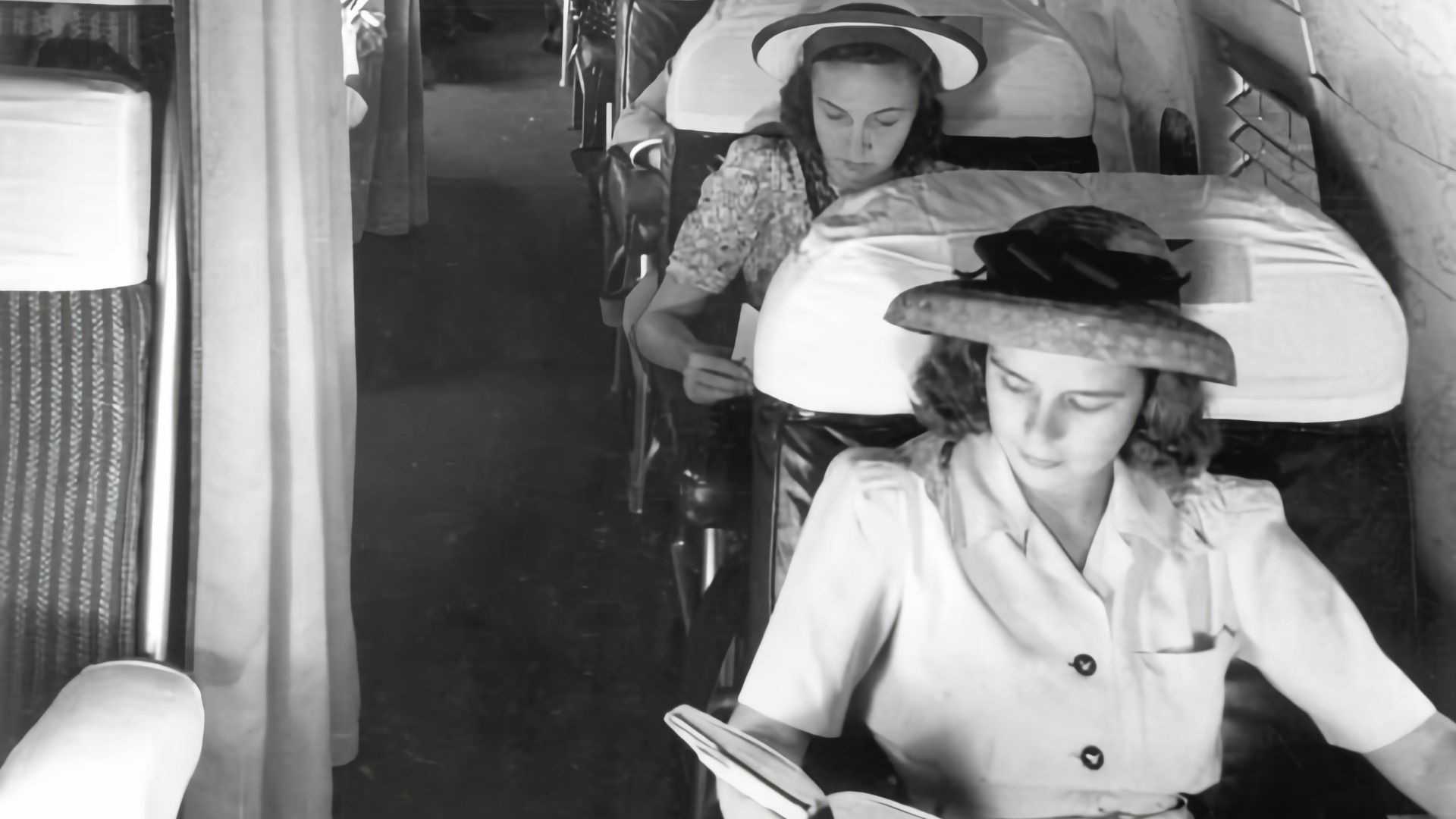 a black and white photo of a group of women on a train