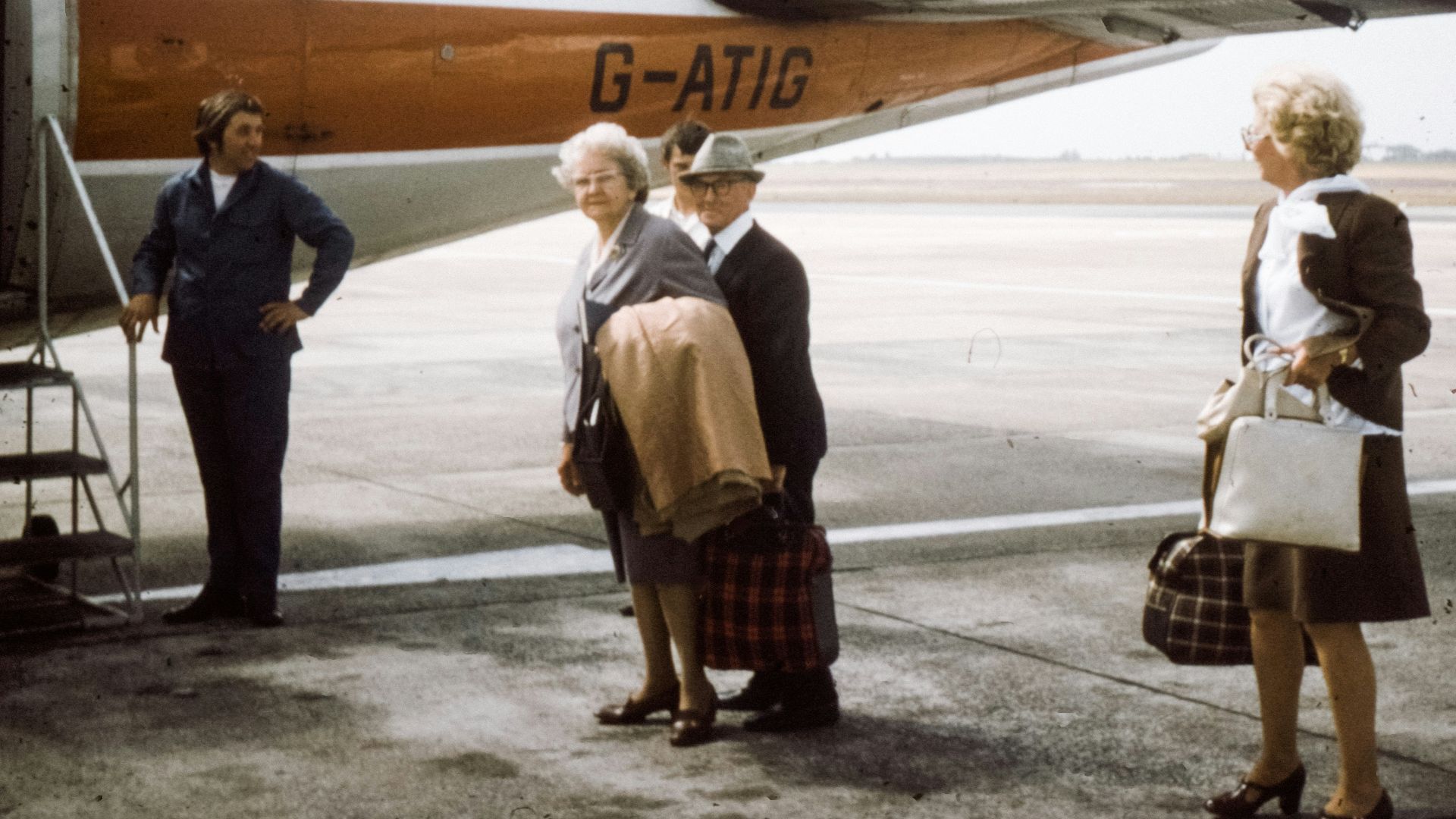 woman standing beside plane