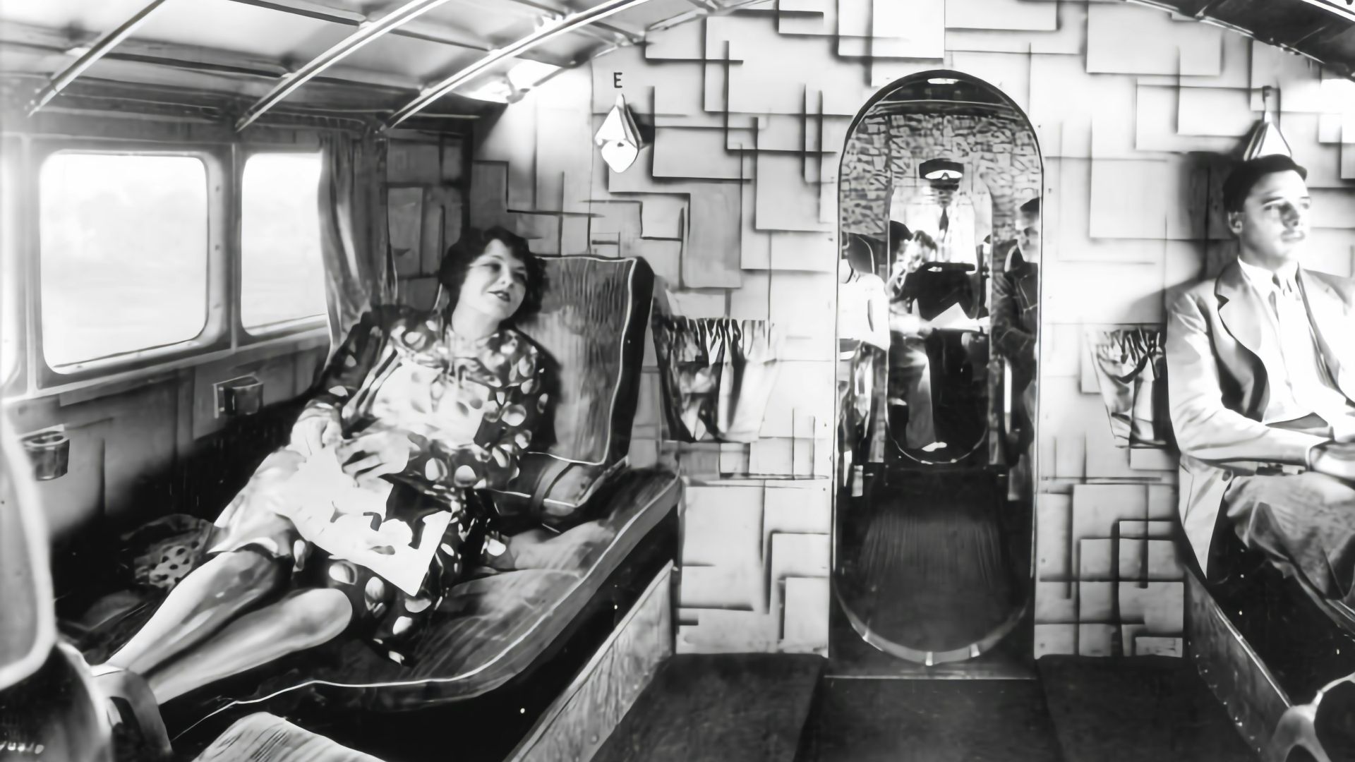 a black and white photo of a man and a woman on a train