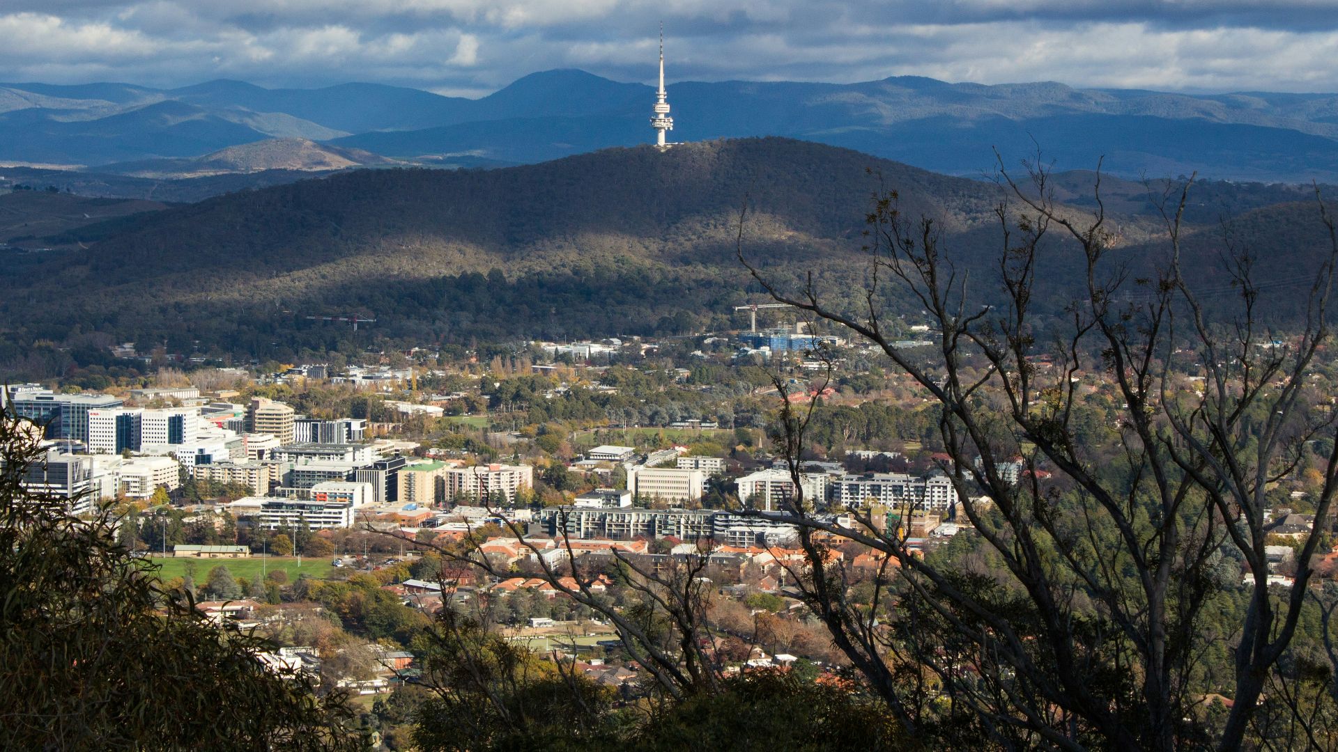 a view of a city with mountains in the background