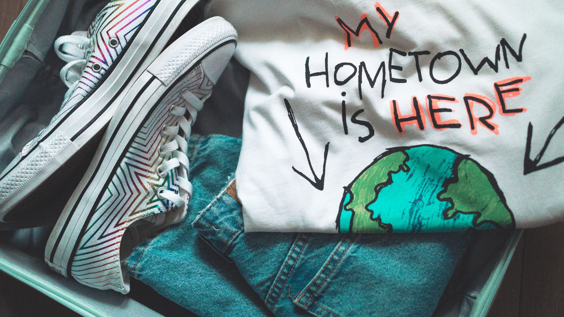 white and black shirt on blue denim jeans