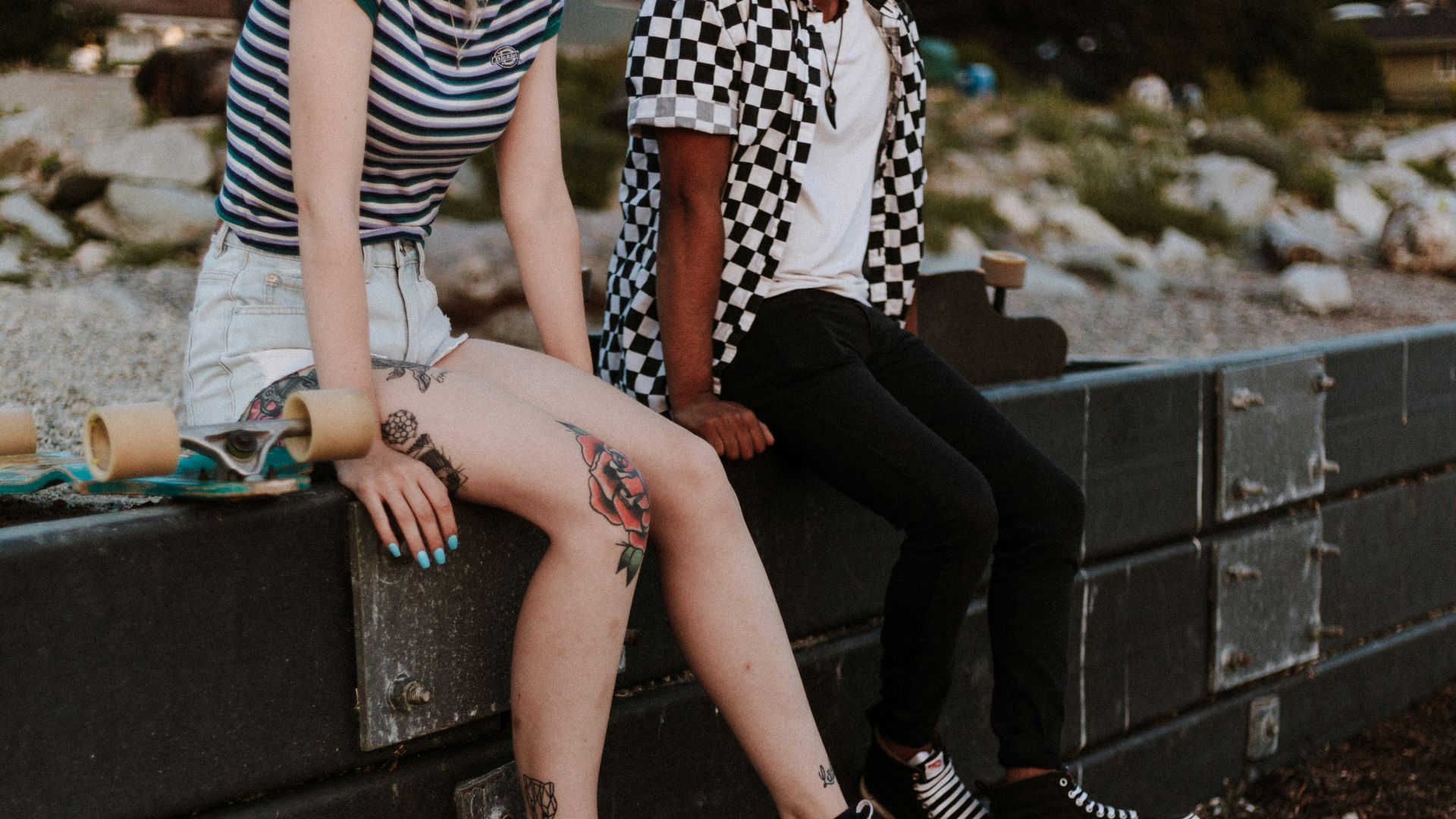 two person sits on fence