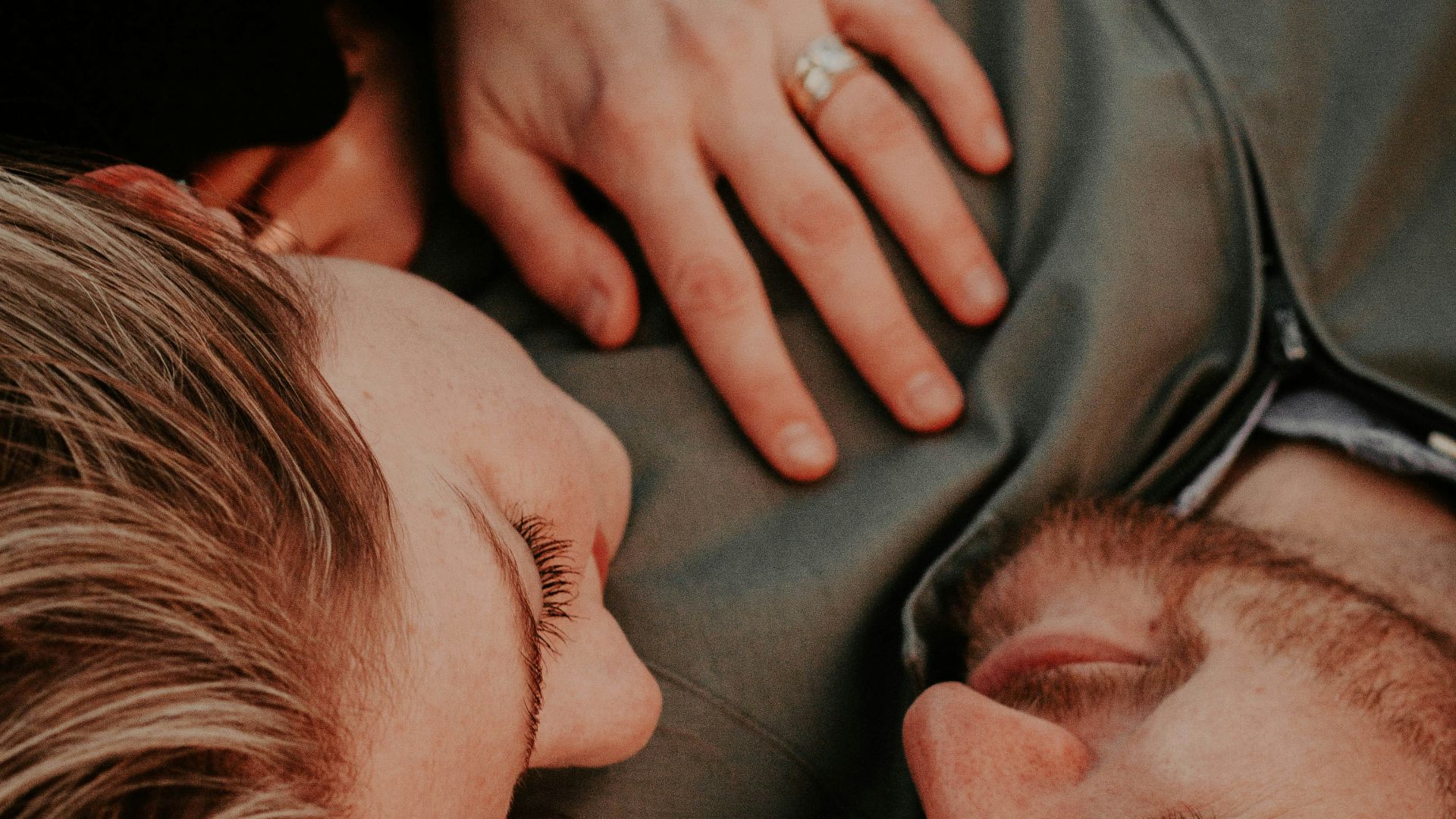 a woman stares into a man's eyes lovingly