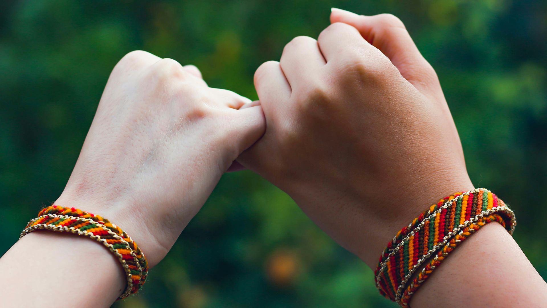 person wearing beaded bracelets and bracelet