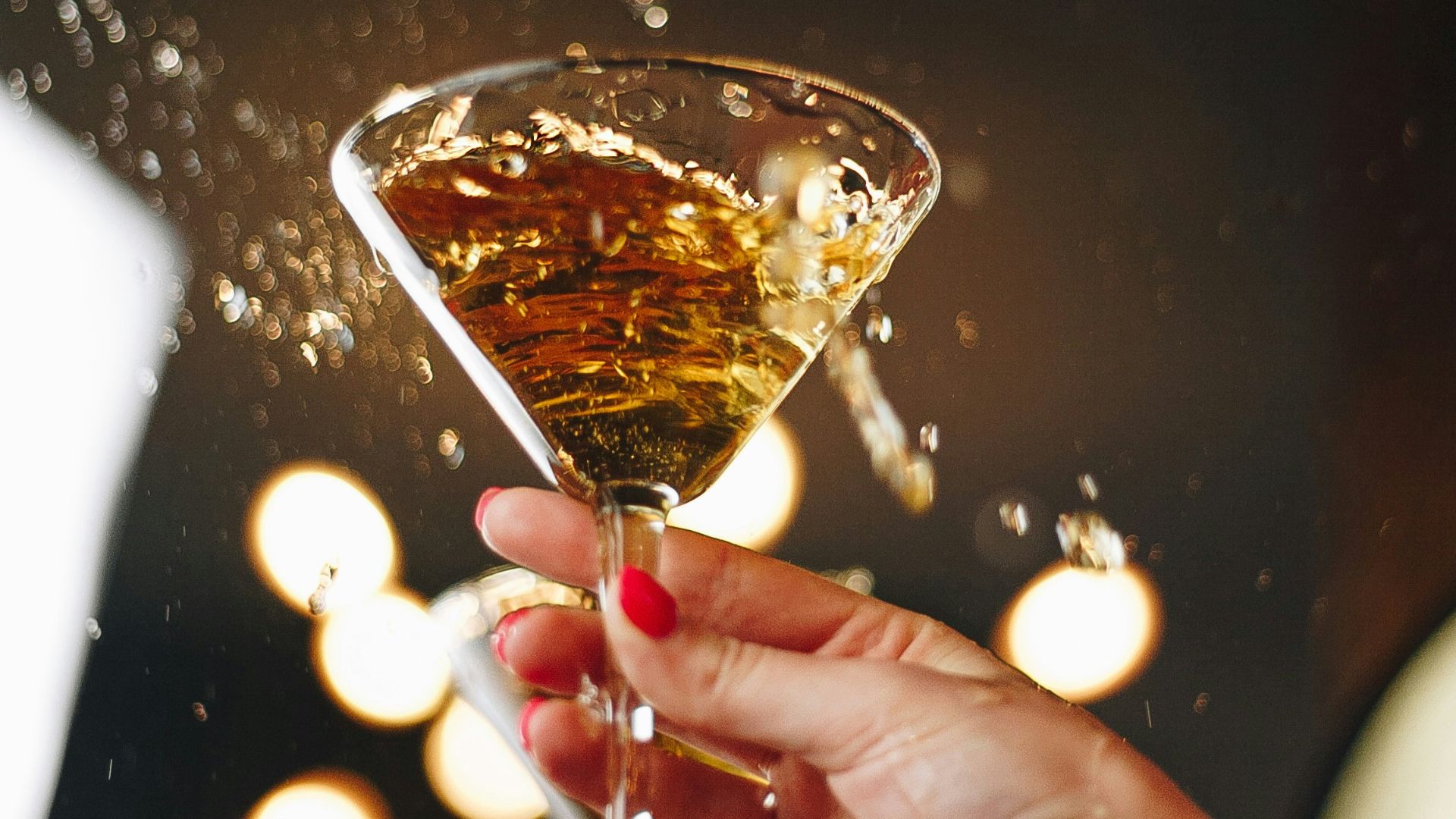 person holding clear wine glass