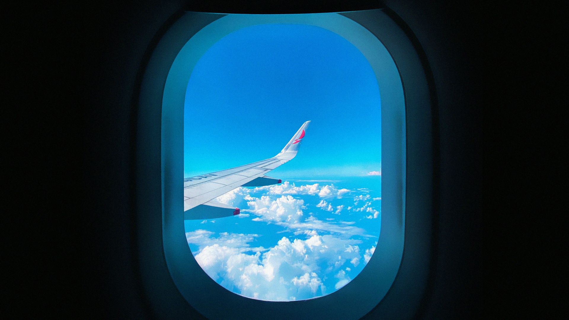 a view of the wing of an airplane through a window