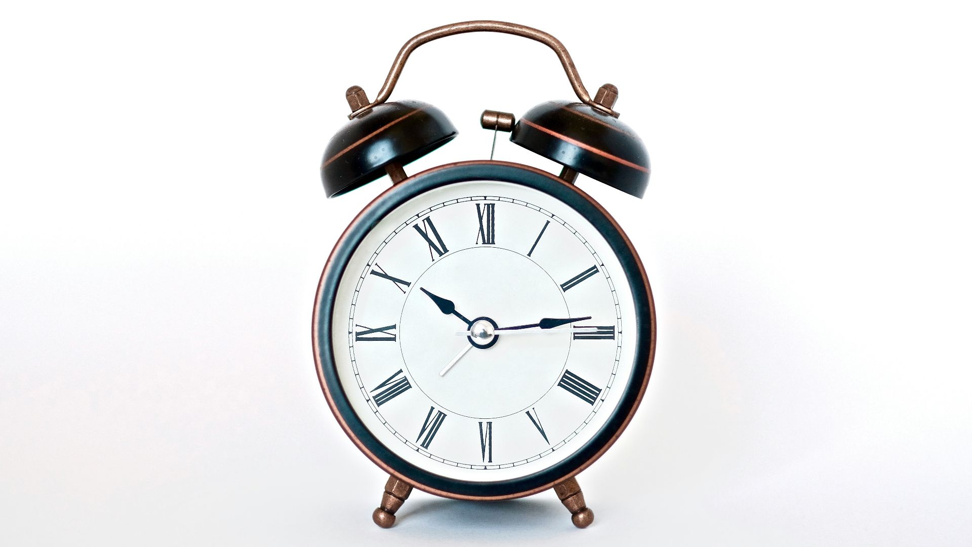 round black and white analog alarm clock