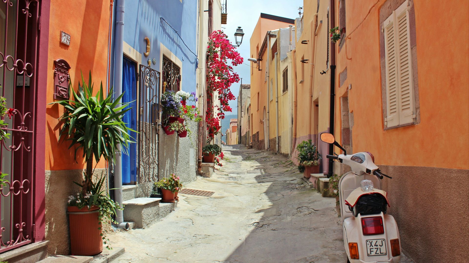 white motor scooter near building