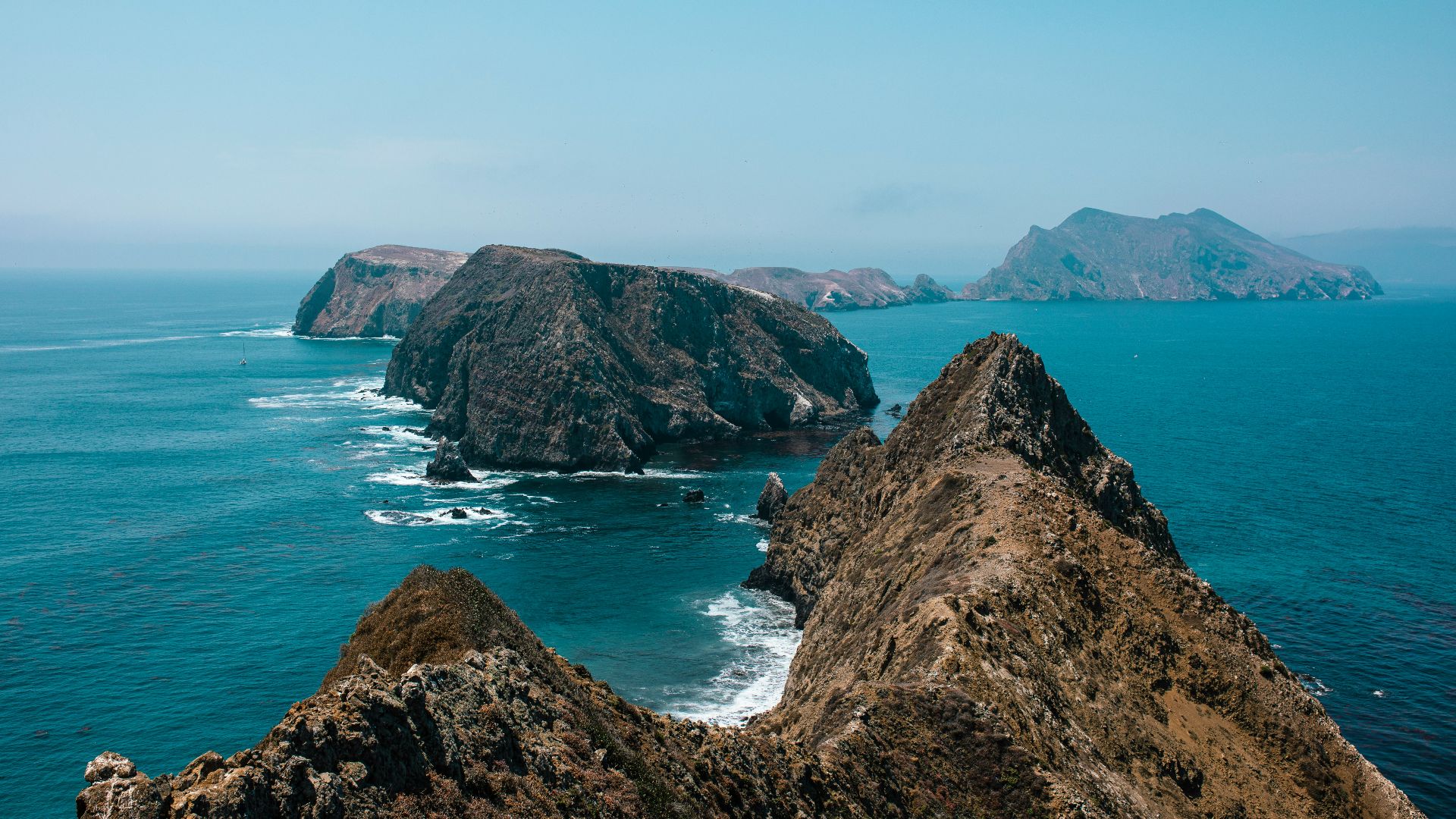 brown rock formation on sea during daytime