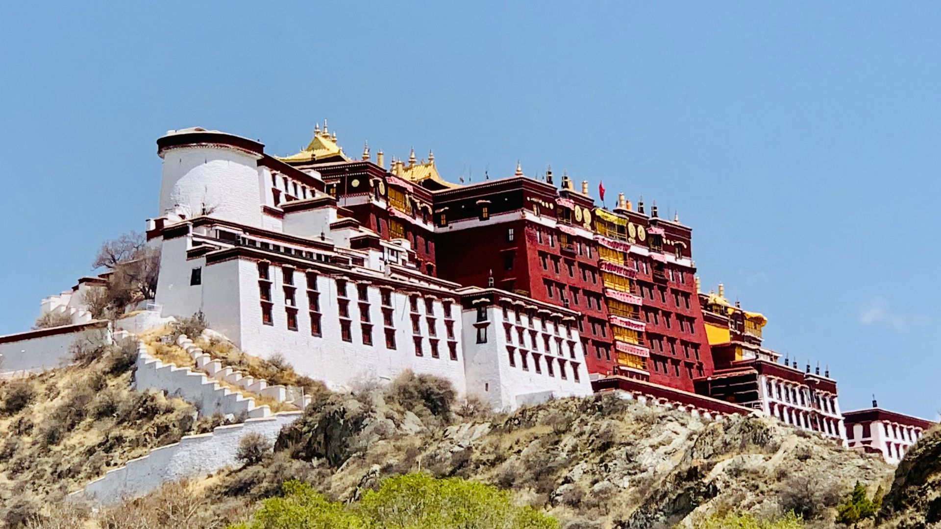 white and red concrete building under blue sky during daytime