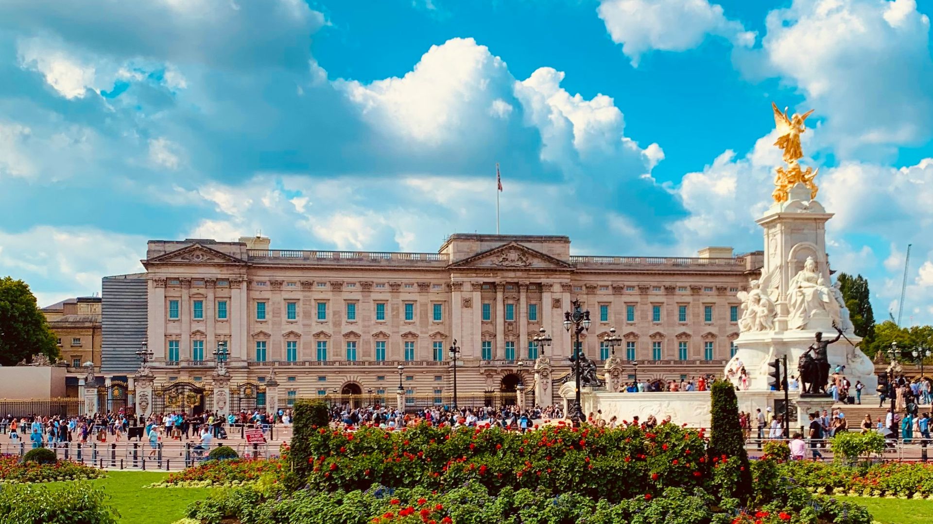 a large building with a statue in the middle of a garden