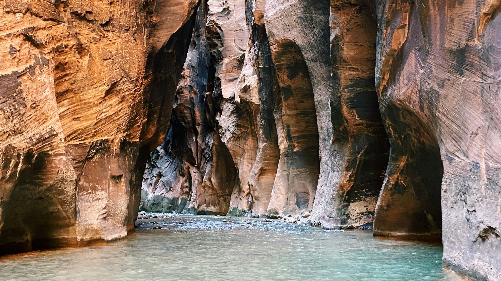 brown rock formation beside body of water during daytime