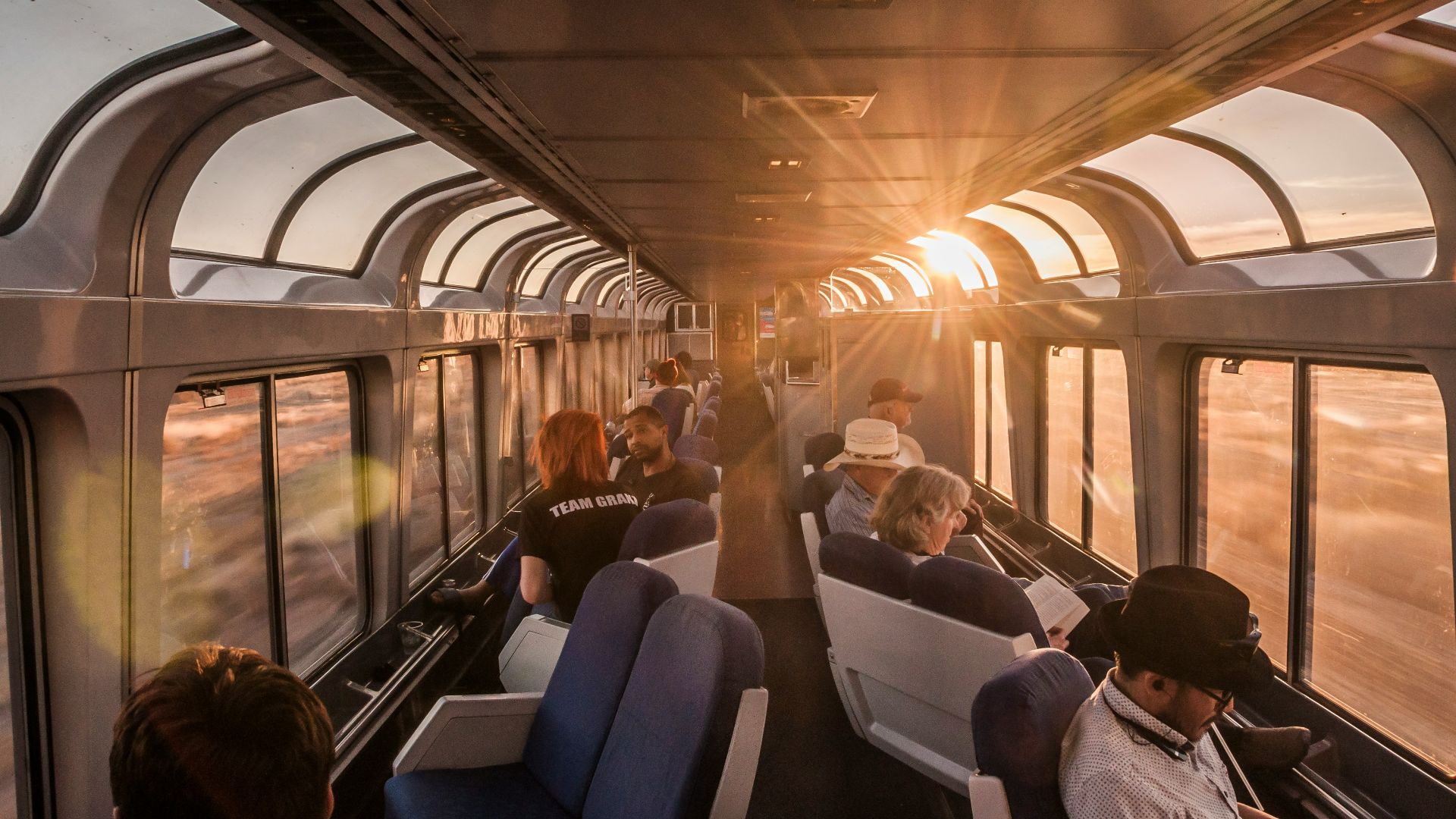 a group of people sitting on a train next to each other