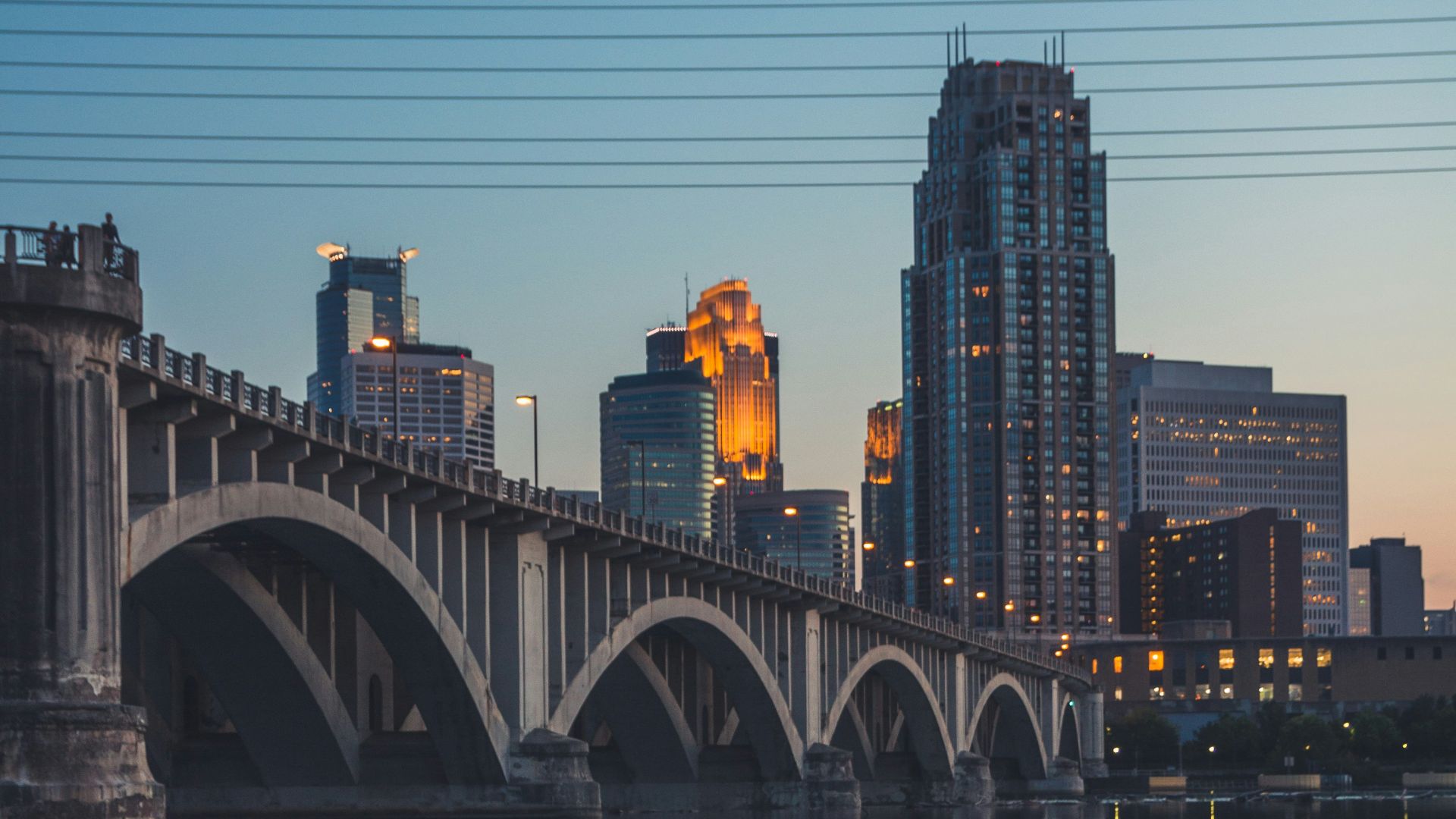 gray concrete bridge over body of water during night time