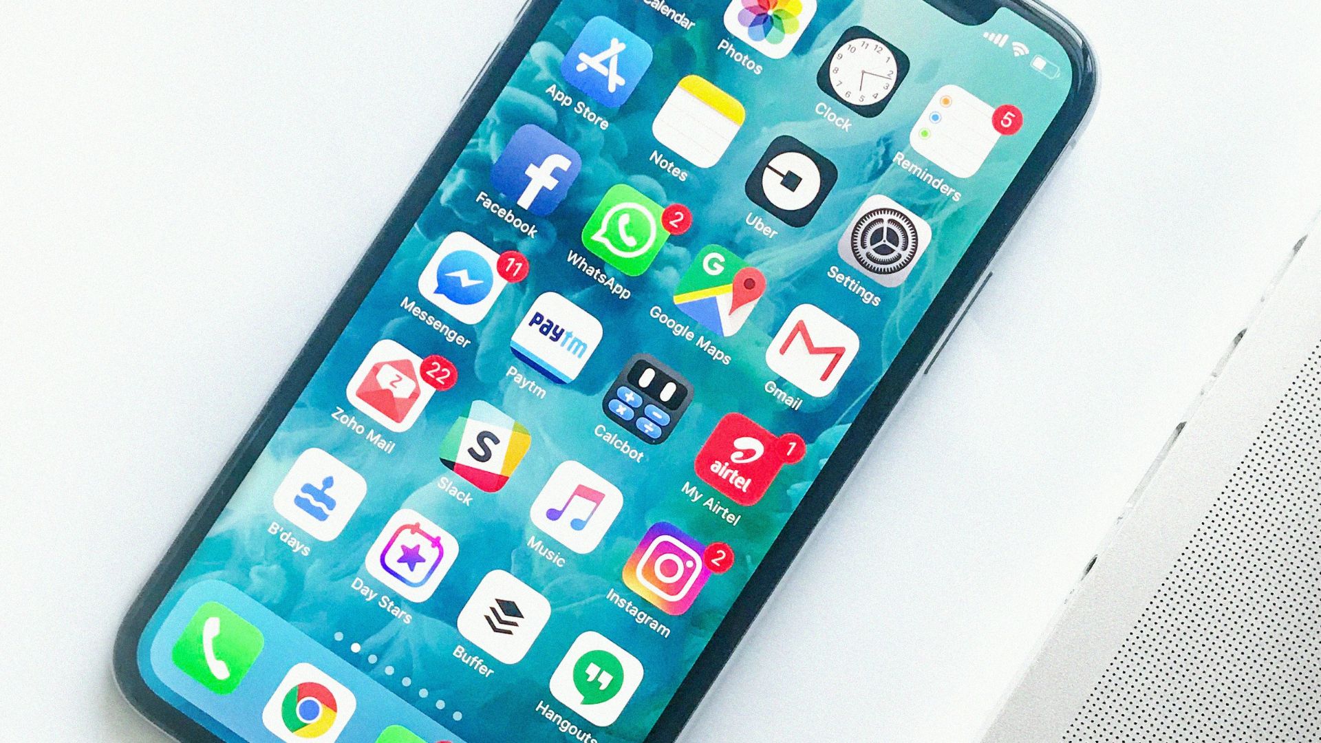 white smartphone near laptop