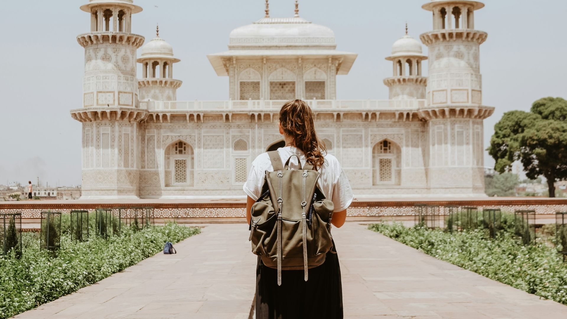 woman near beige painted building