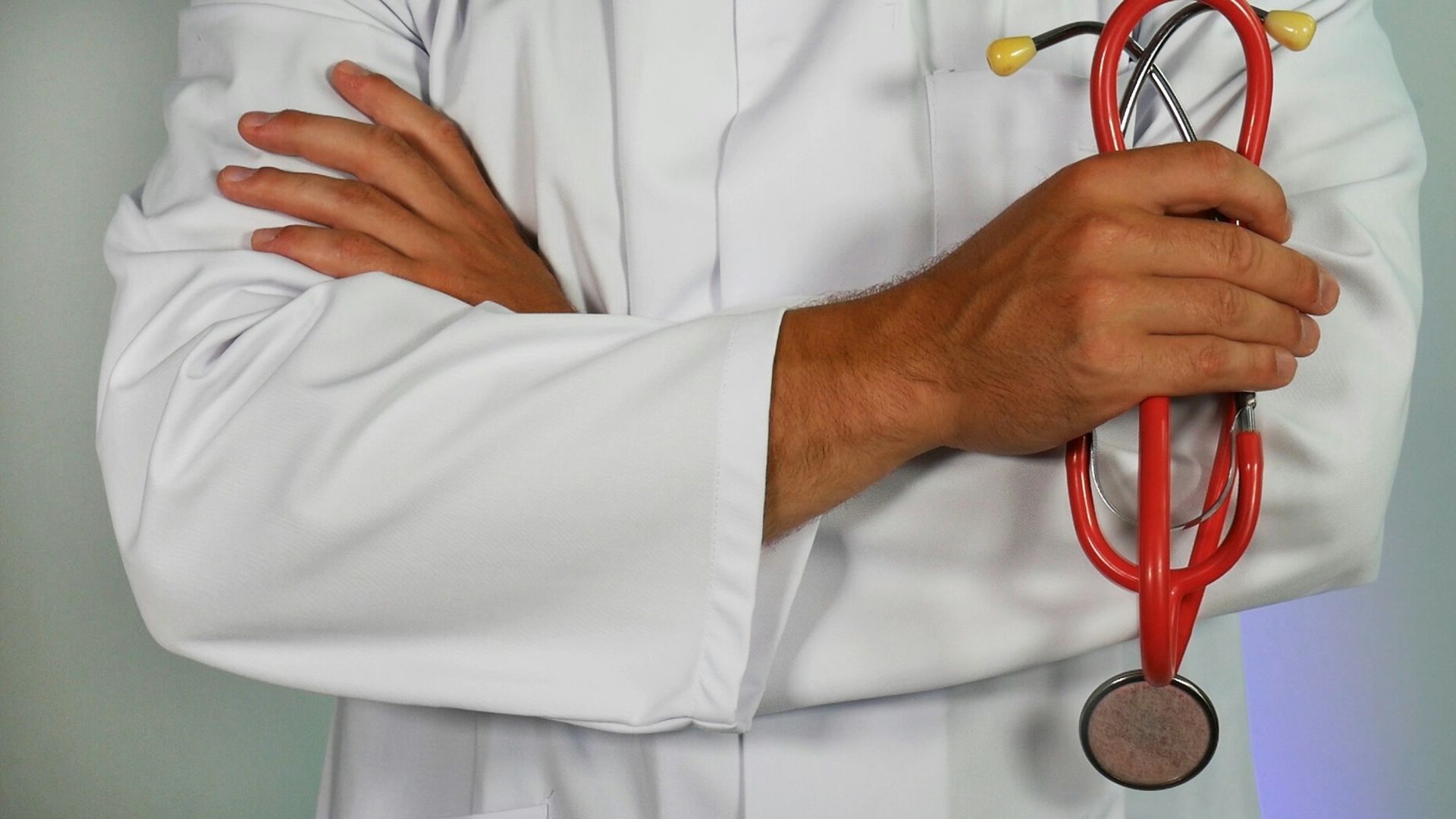 doctor holding red stethoscope