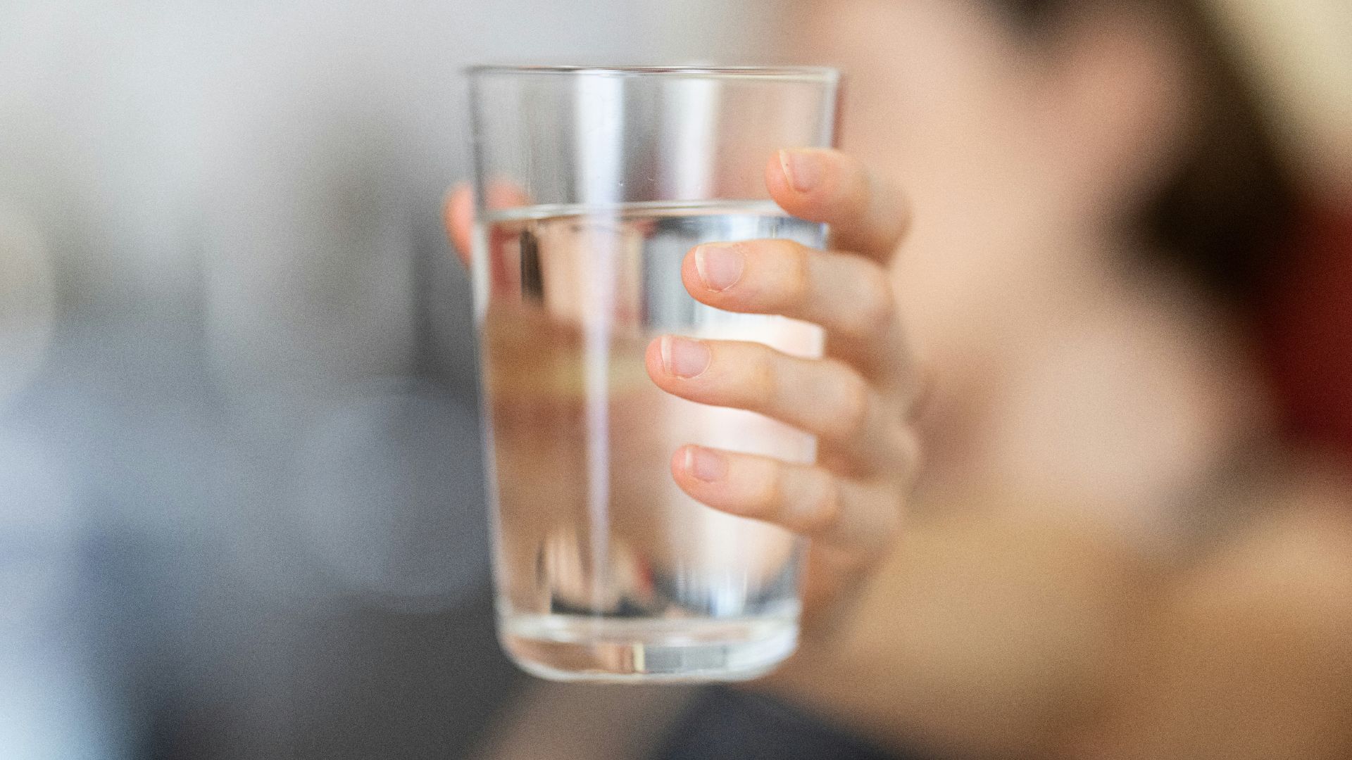 person holding clear drinking glass