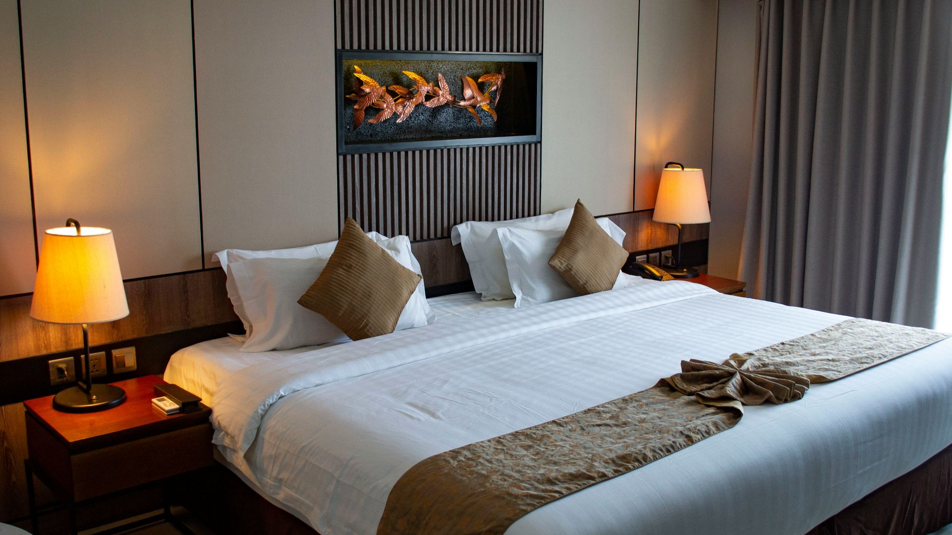 white bed linen with throw pillows