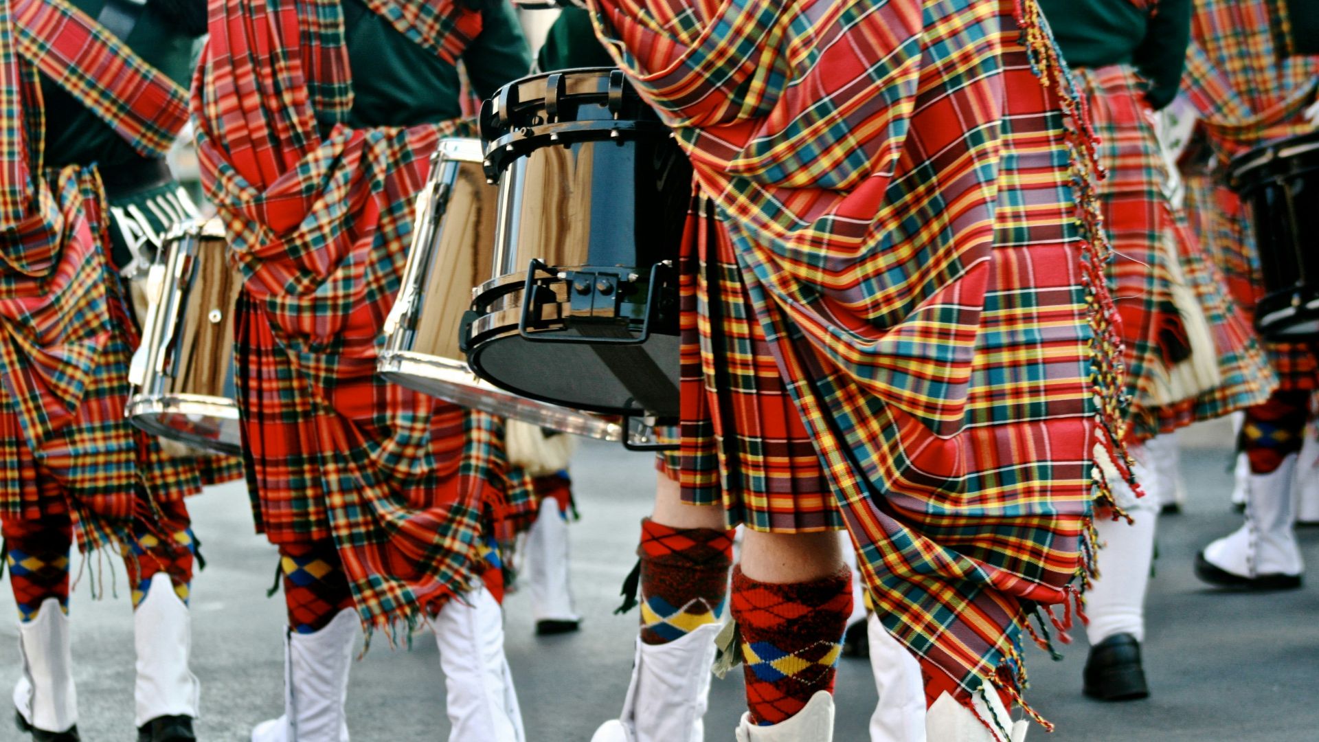 person in red and white plaid shirt and white pants