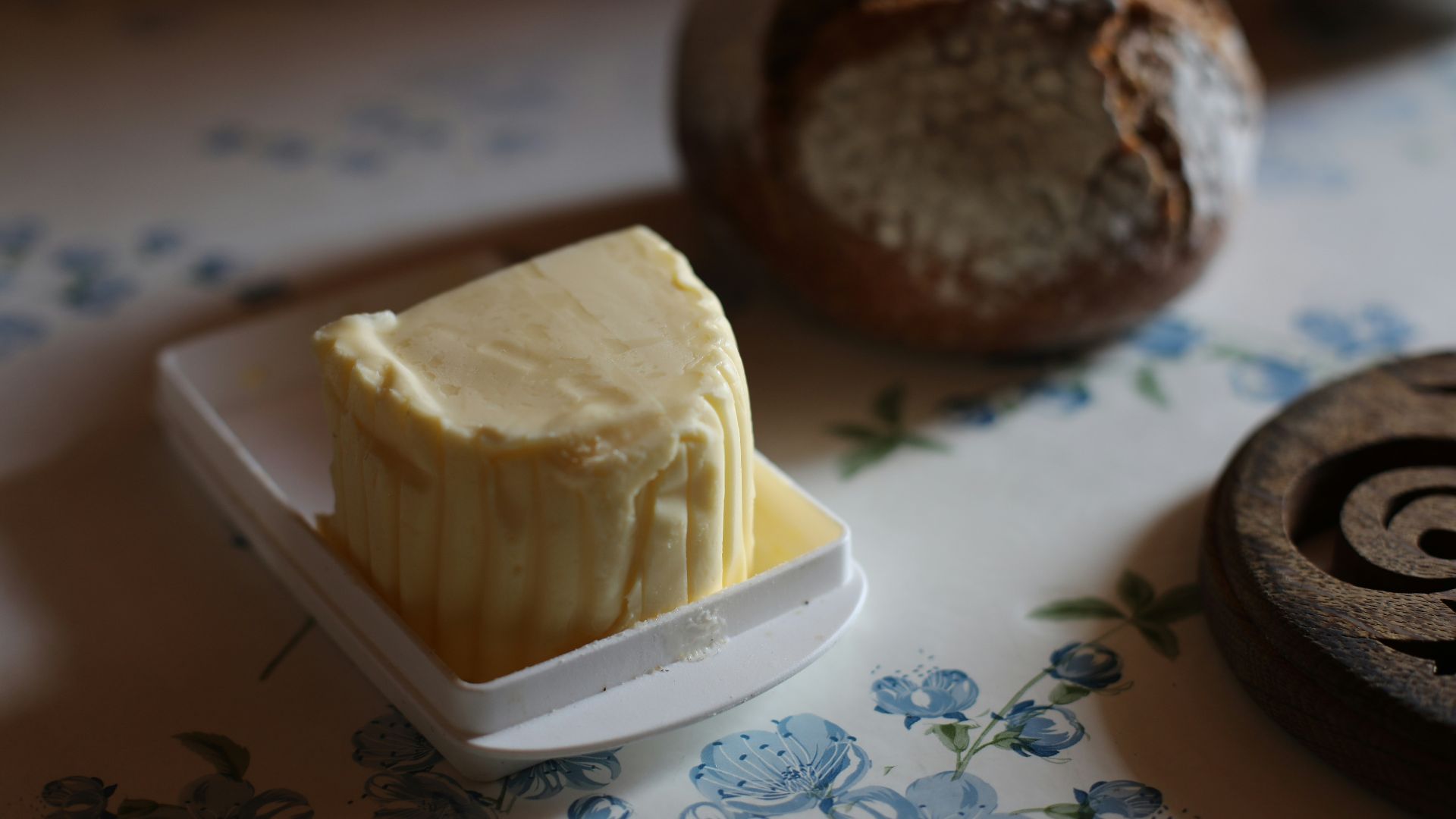 A piece of butter sitting on top of a white plate