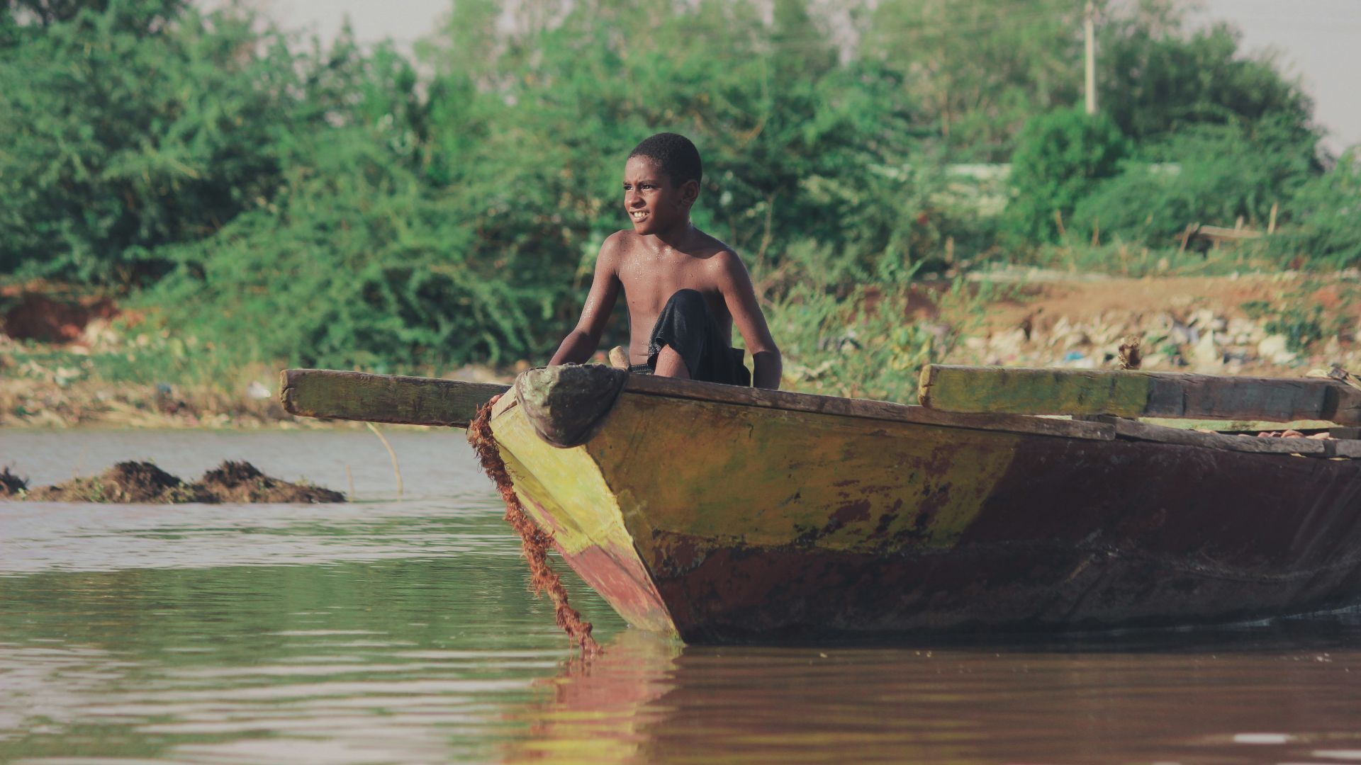 man in brown boat on river during daytime