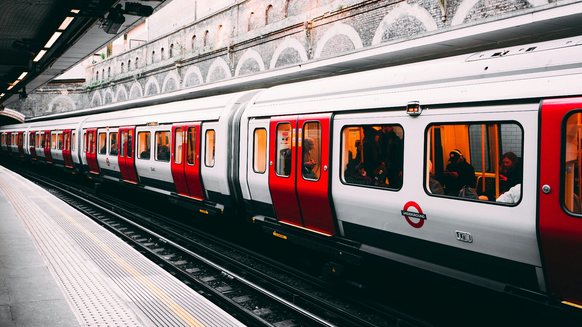 white and red train beside building at daytime