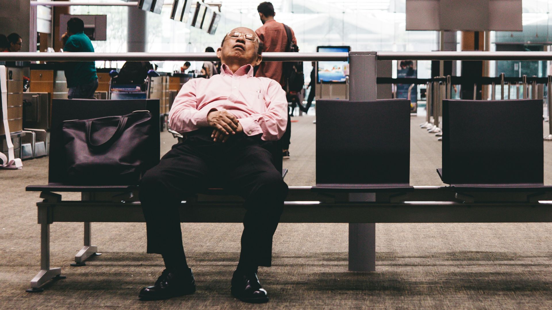 person sleeping on gang chair