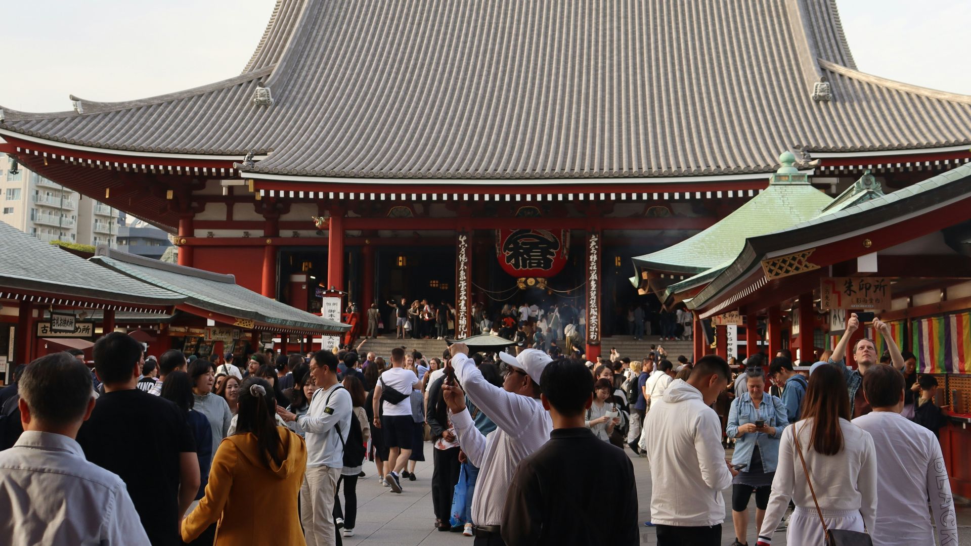a group of people walking in front of a building
