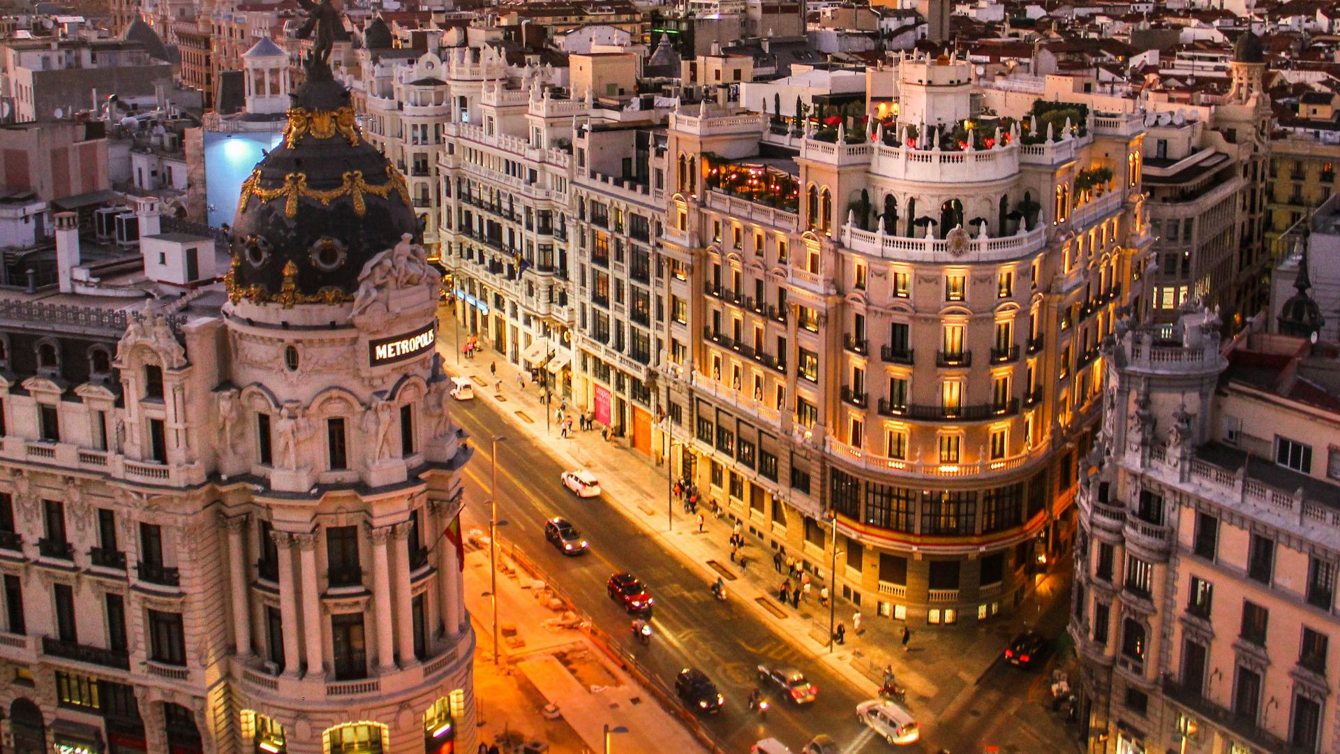 aerial photography of vehicles passing between high rise buildings