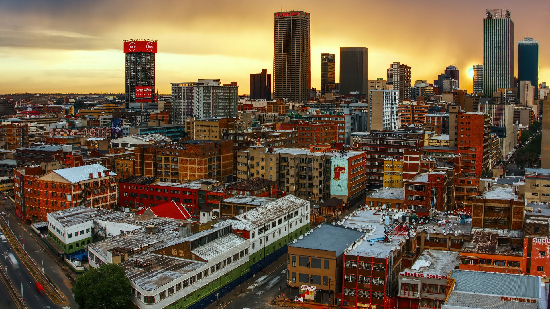 a view of a city with a train in the foreground