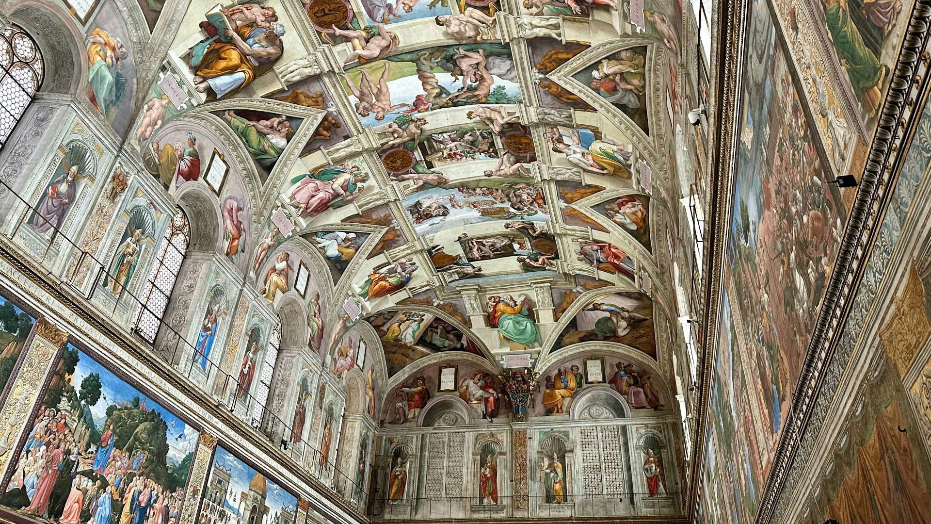 The ceiling of a building with many paintings on it