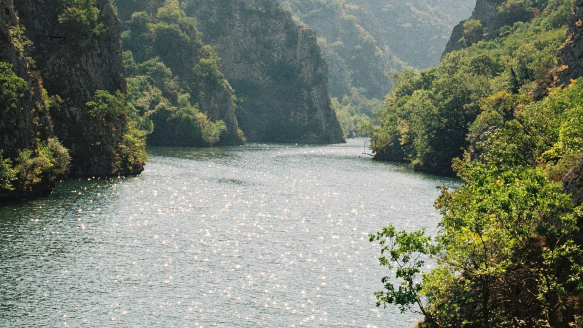 a body of water surrounded by mountains and trees