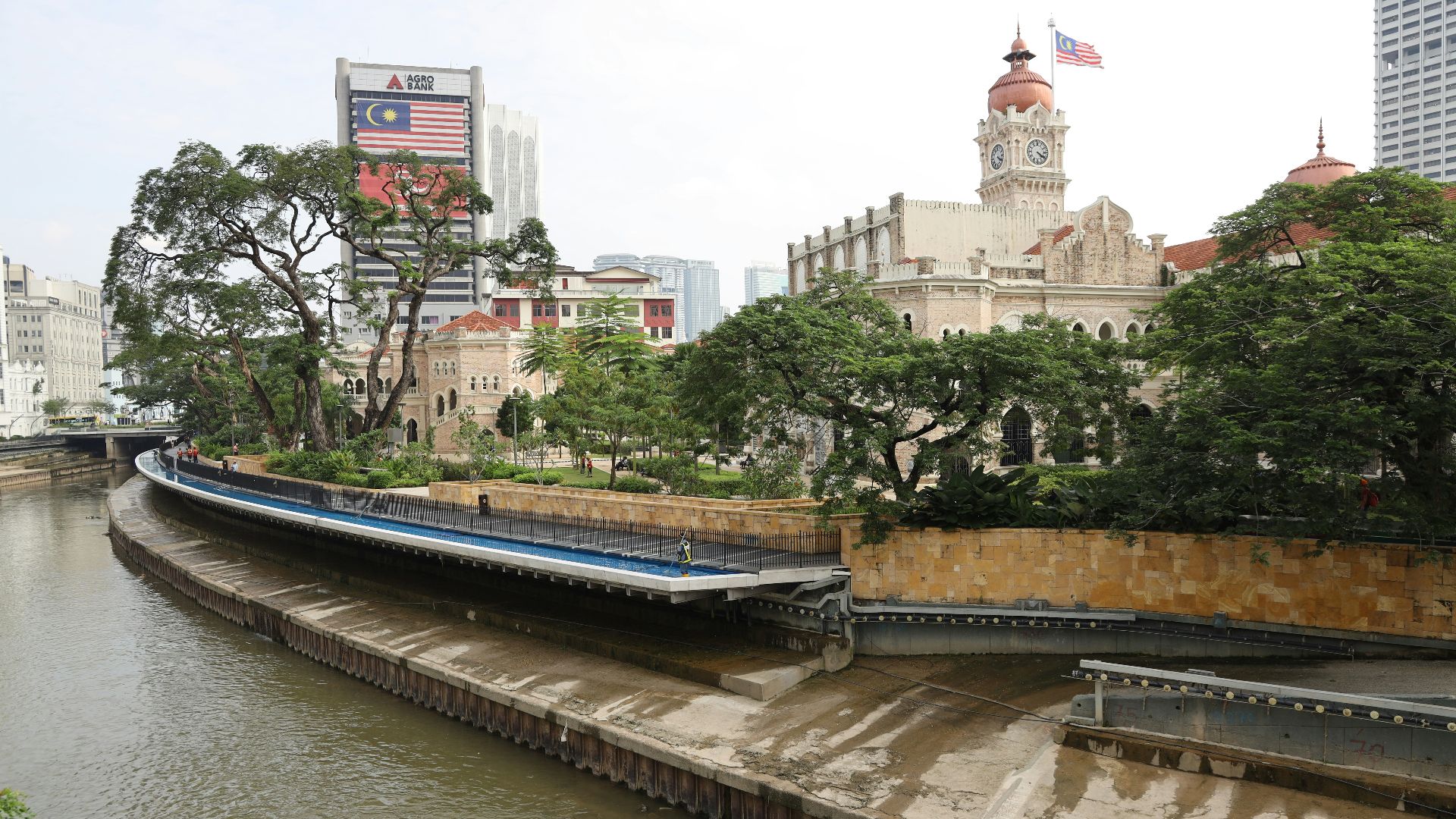 a river running through a city next to tall buildings
