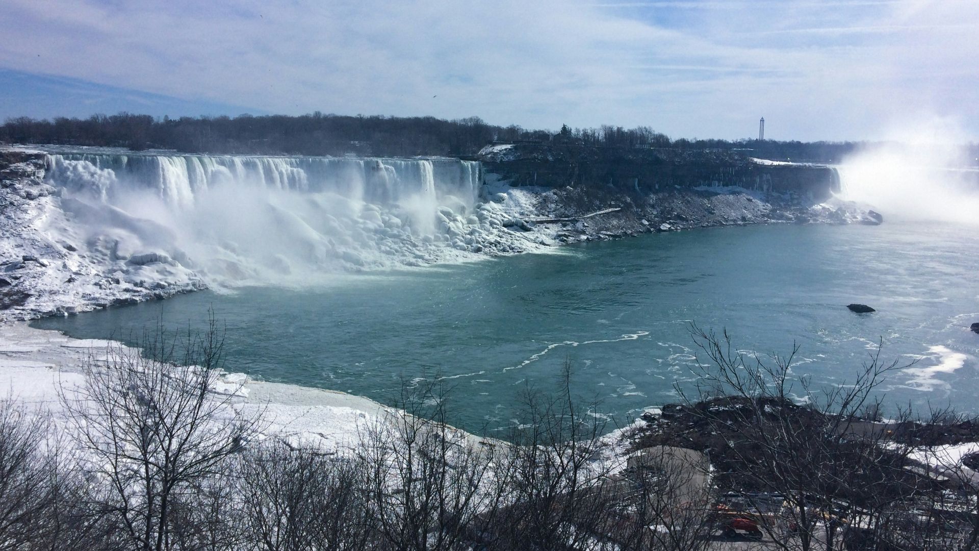 water falls under blue sky during daytime