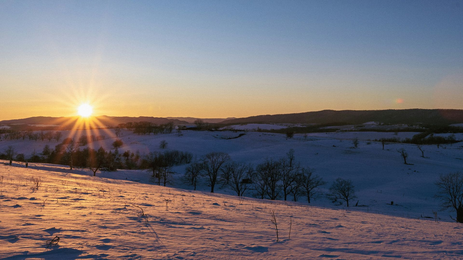 Sunset over a snowy landscape.