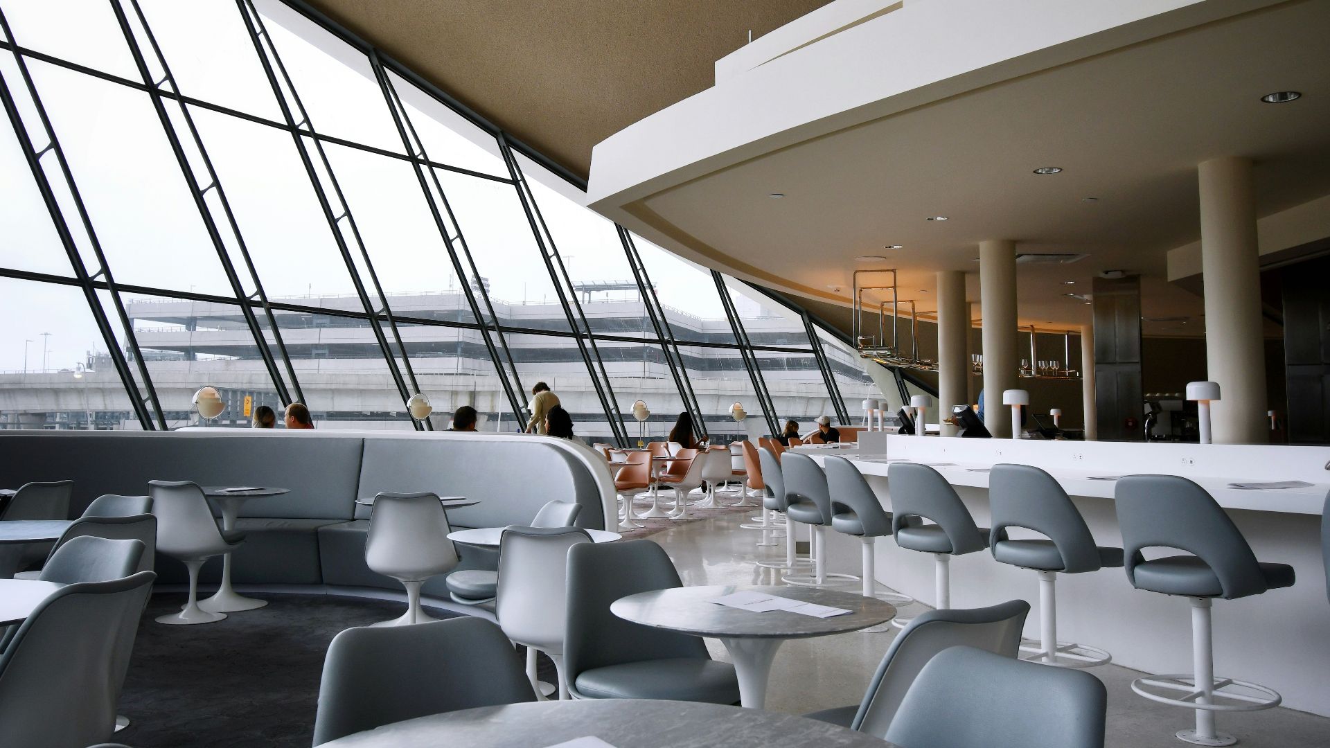 people sitting on white chairs inside building