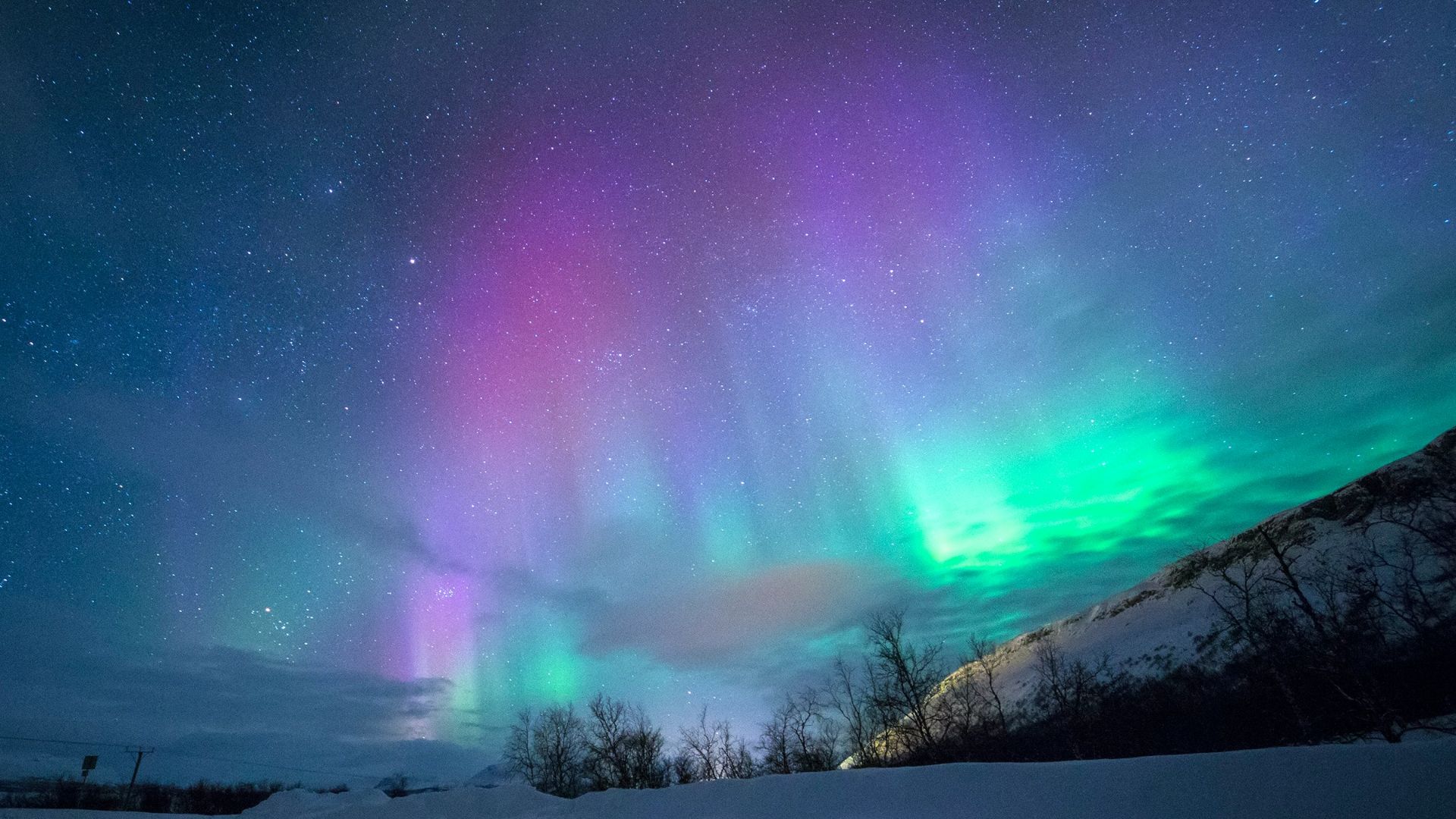 northern lights over snow-capped mountian