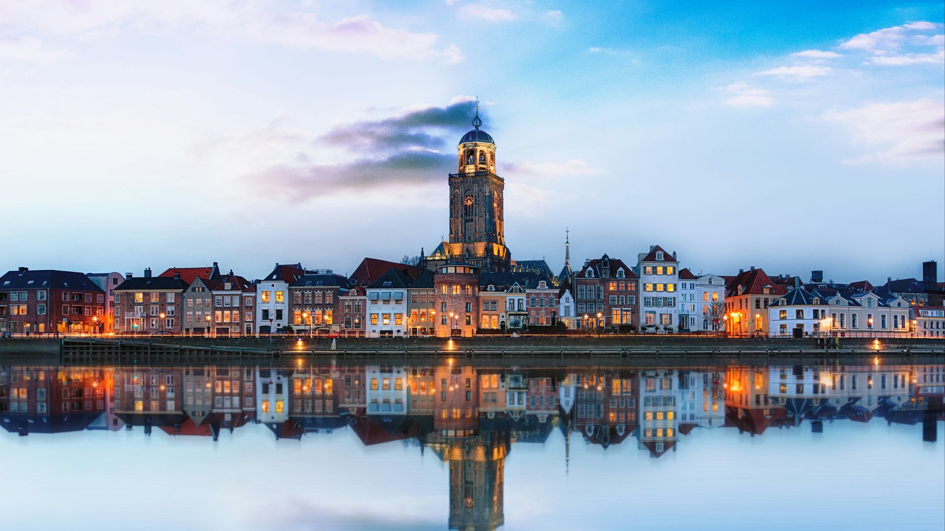 lighted buildings across placid lake
