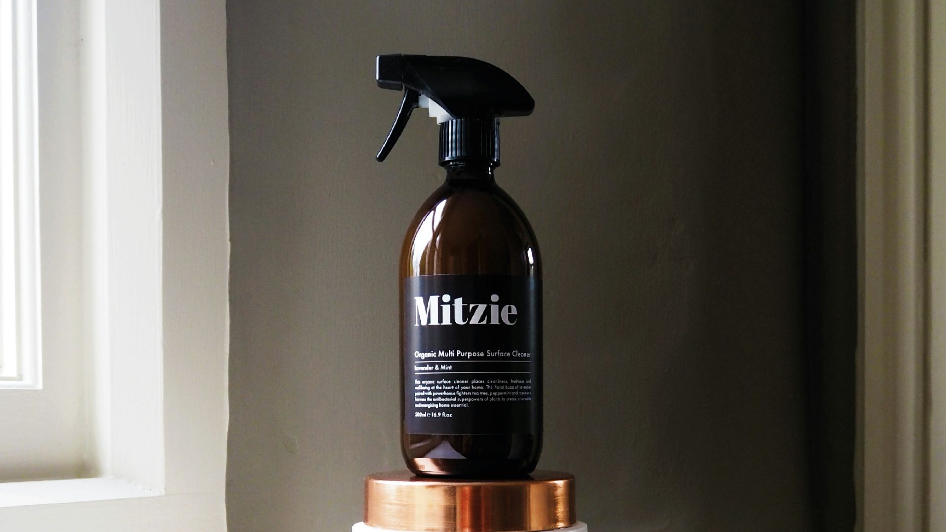 black Mitzie spray bottle near window