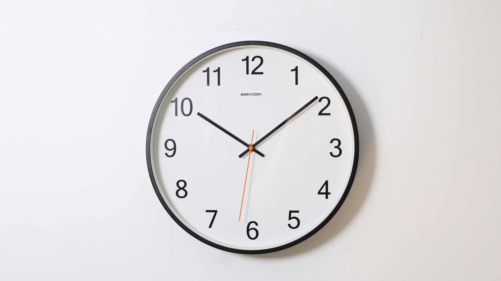 round analog wall clock pointing at 10:09